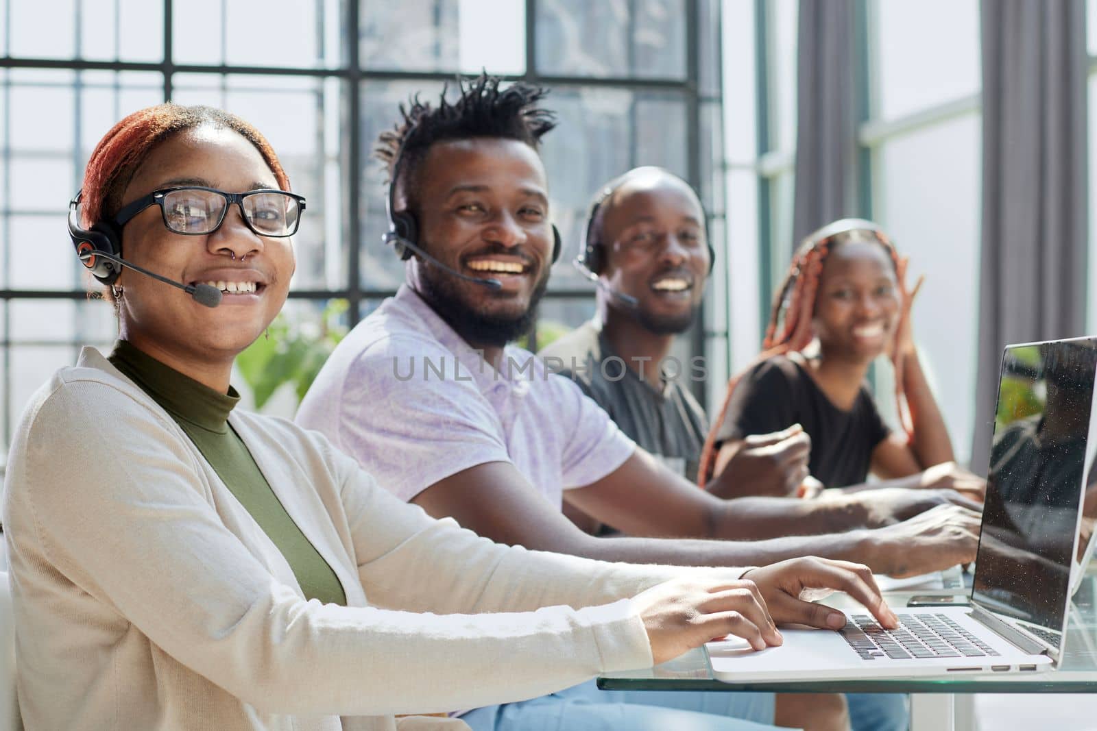 African american team working at call center office to help people with telemarketing assistance by Prosto