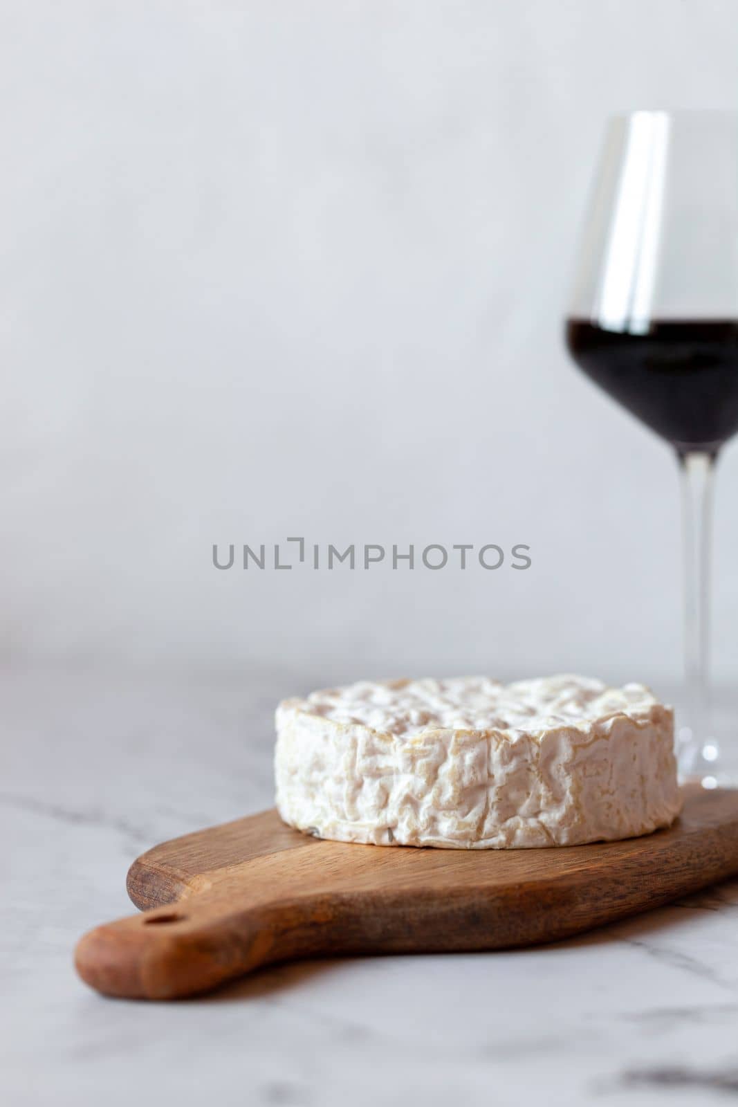 camembert soft cheese served with a glass of red wine
