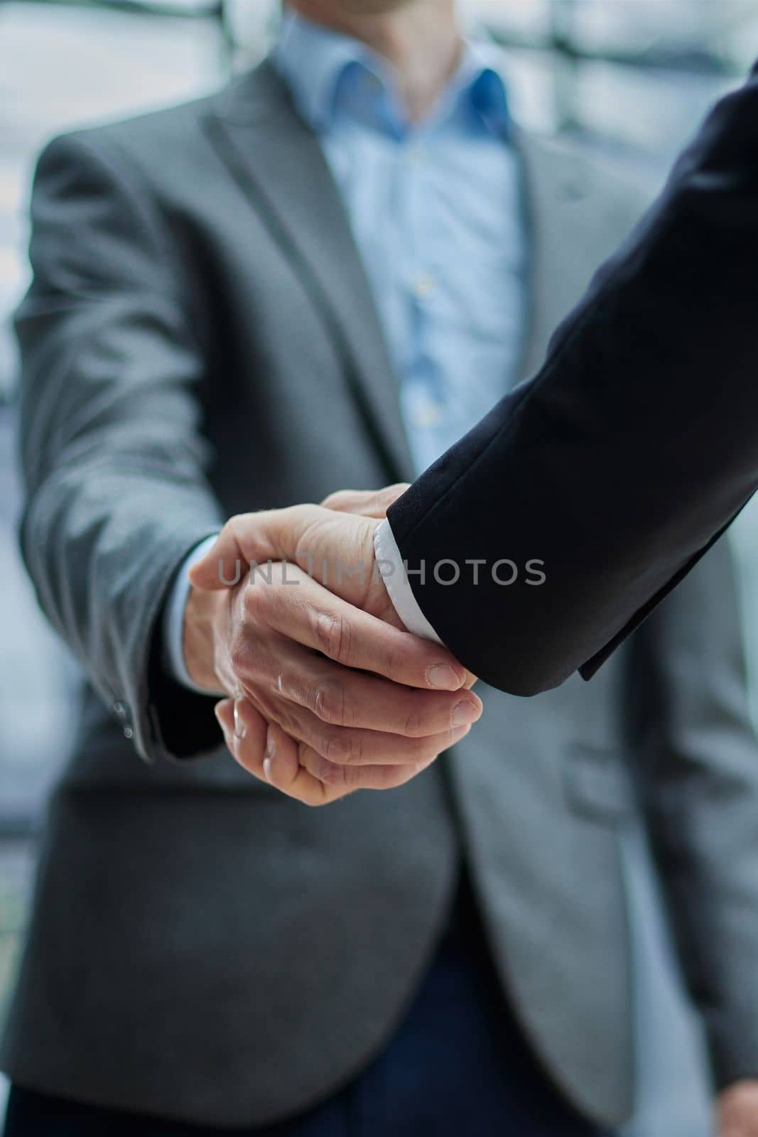 Two diverse professional business men executive leaders shaking hands at office meeting by Prosto