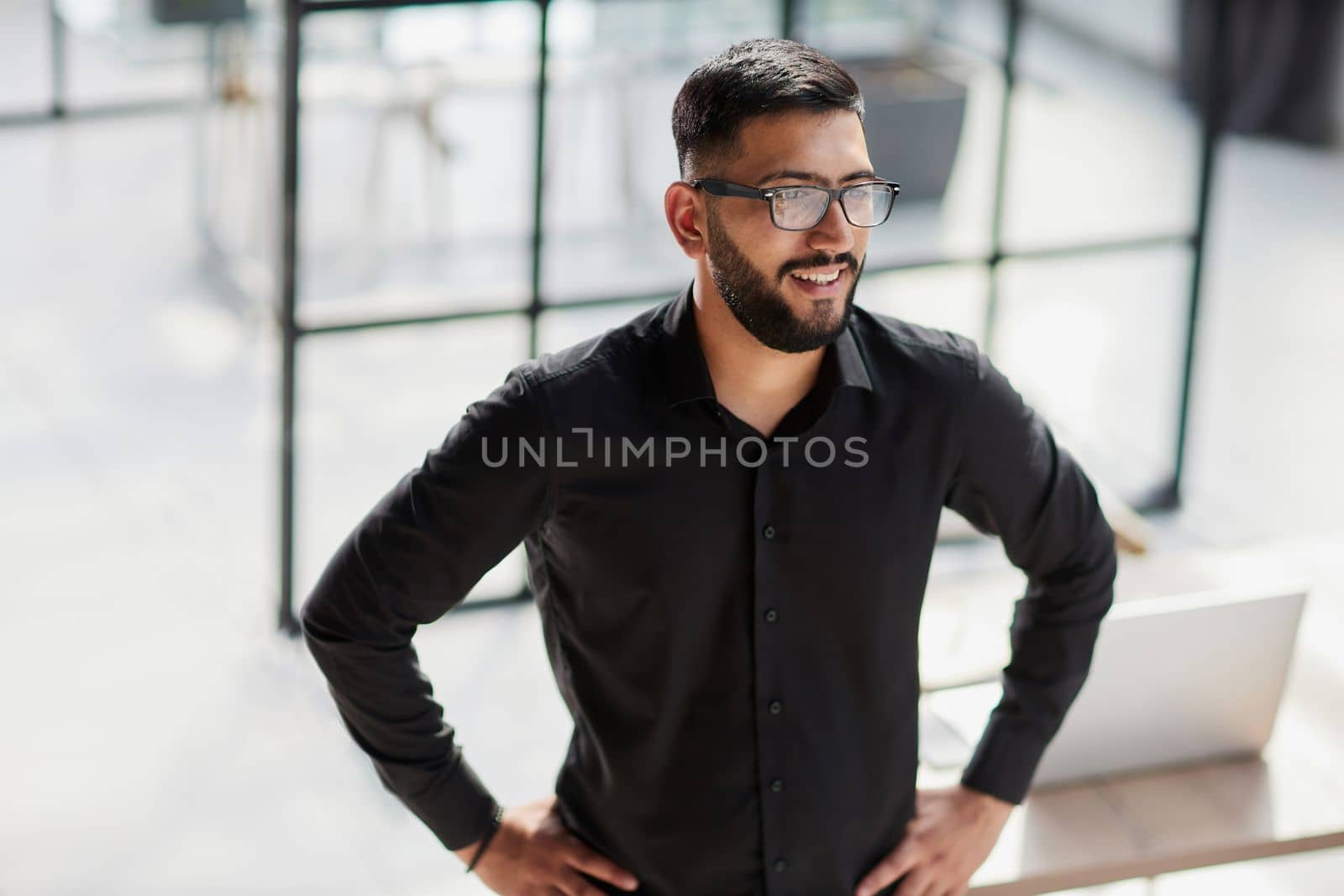 Businessman portrait. Happy confident young businessman standing , smiling, looking at camera.