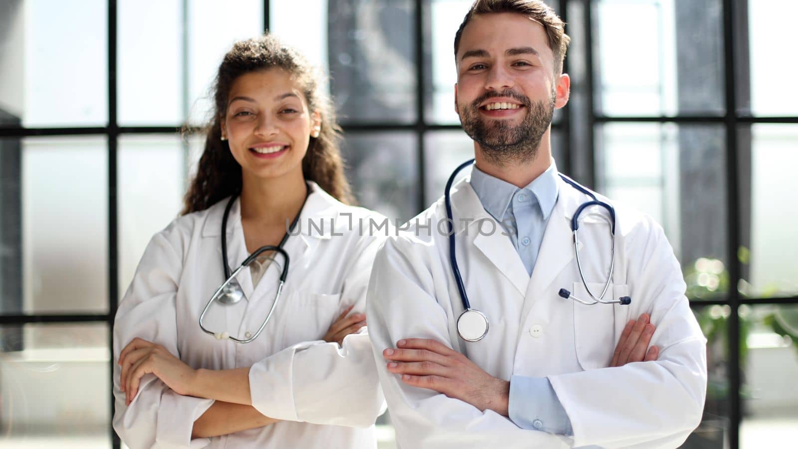 female doctor and male doctor stand in the lobby of the hospital