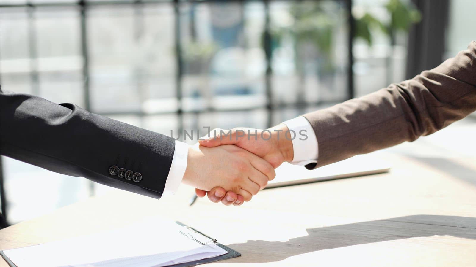 Business shaking hands, finishing up meeting. Successful businessmen handshaking after good deal. by Prosto