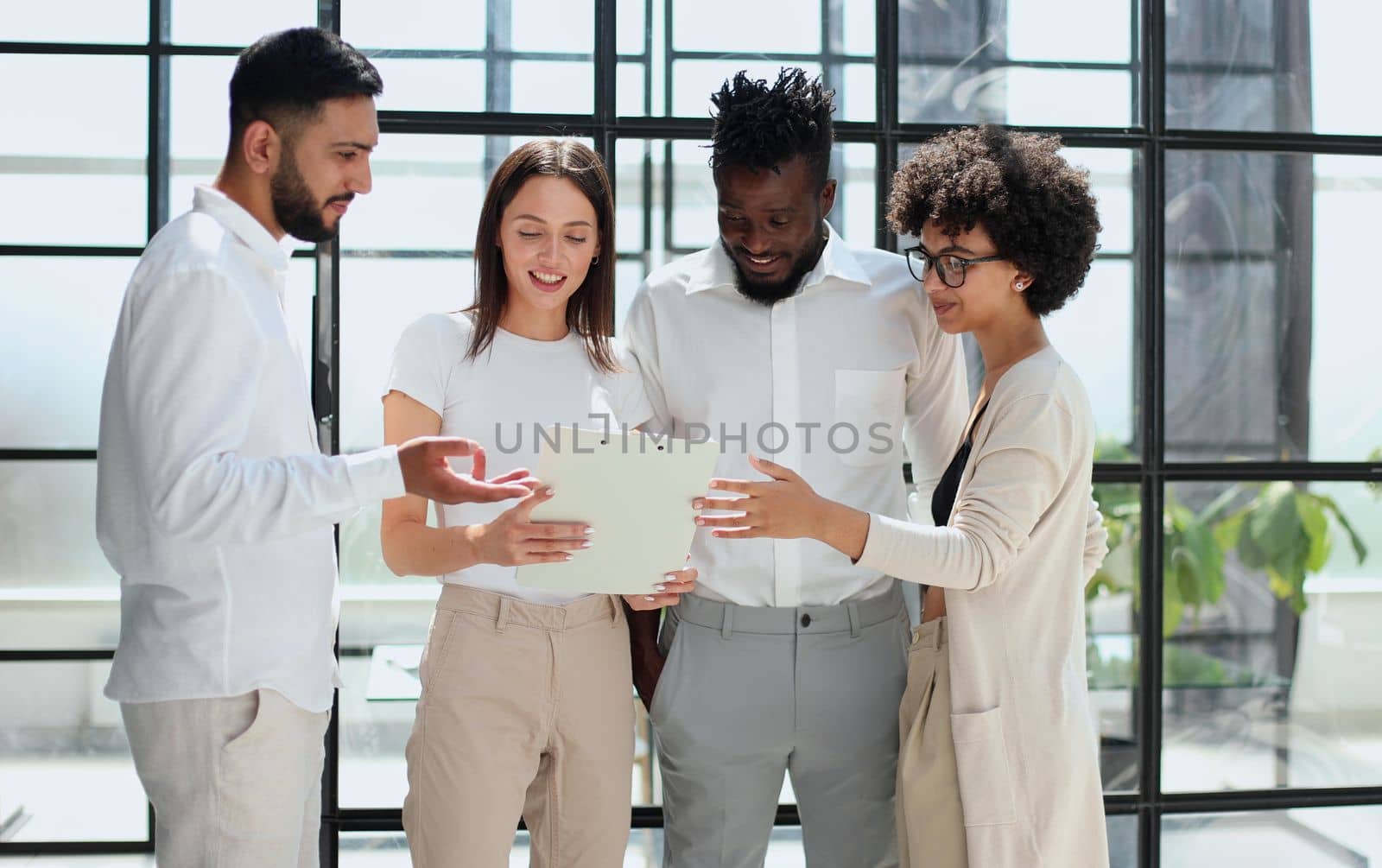 Employees working at computer together, discussing content by Prosto