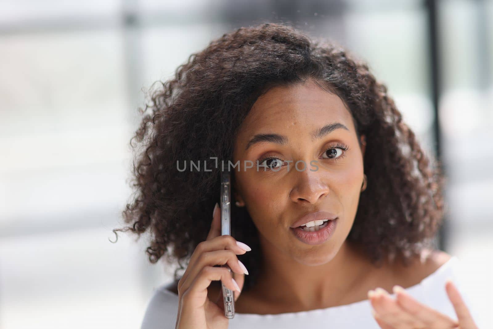 Portrait of a young African American woman talking on the phone