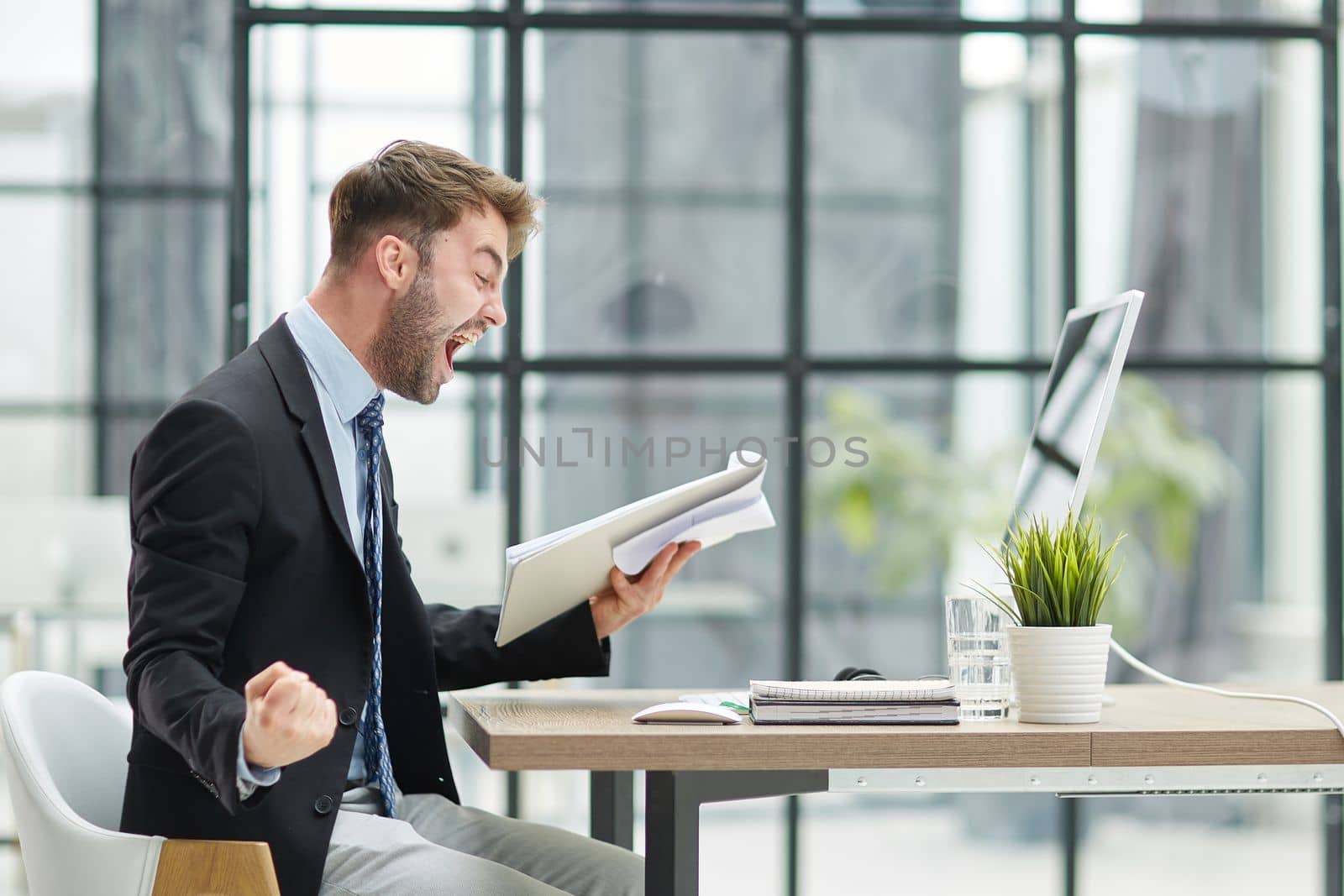 energetic businessman celebrating in office