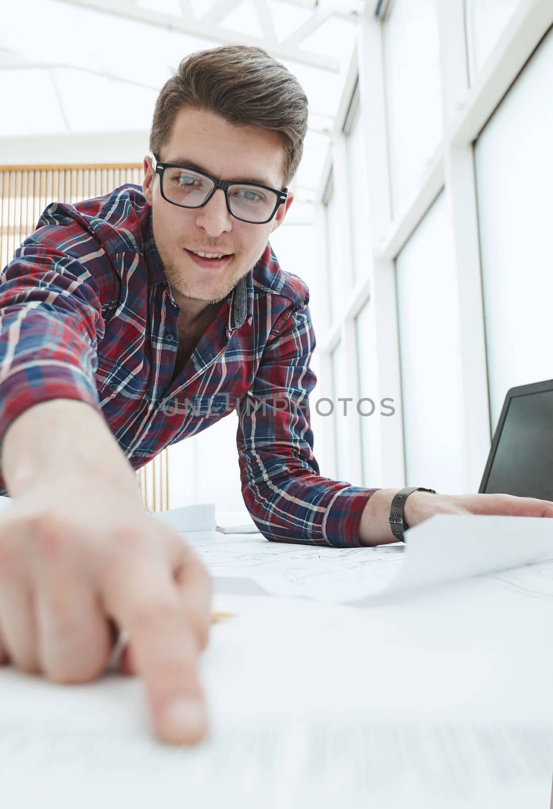 Male Architect working at the modern light office