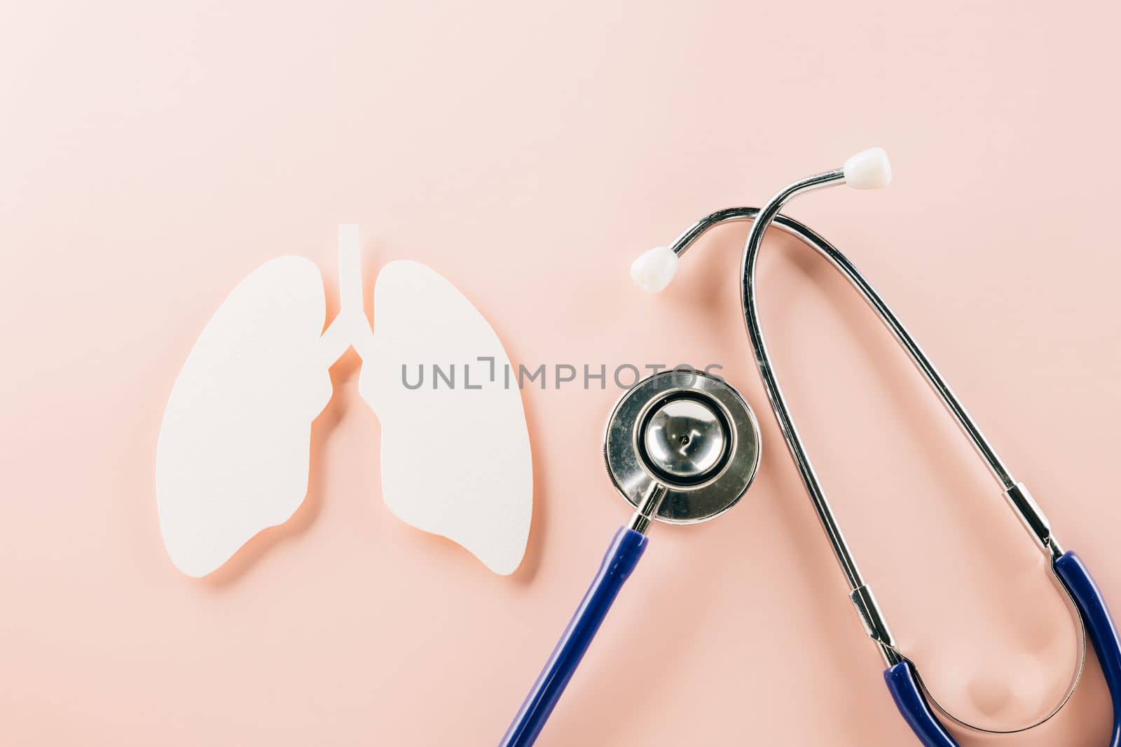 World TB Day. Top view of lungs paper symbol and medical stethoscope on pink background, copy space, lung cancer awareness, concept of world tuberculosis day, banner background, pneumonia