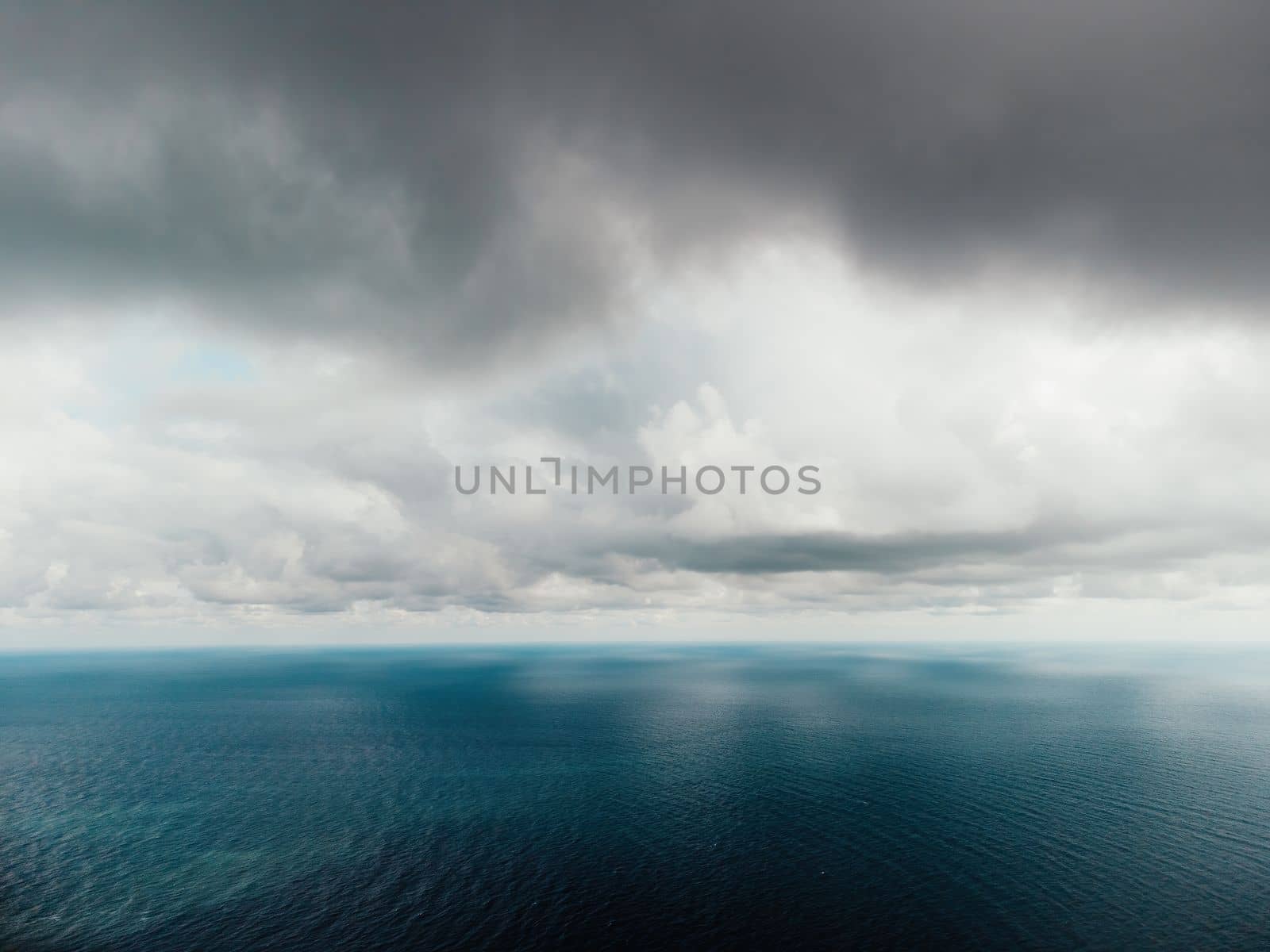 Abstract nature summer or spring ocean sea background. Small waves on water surface in motion blur with bokeh lights from sunrise.