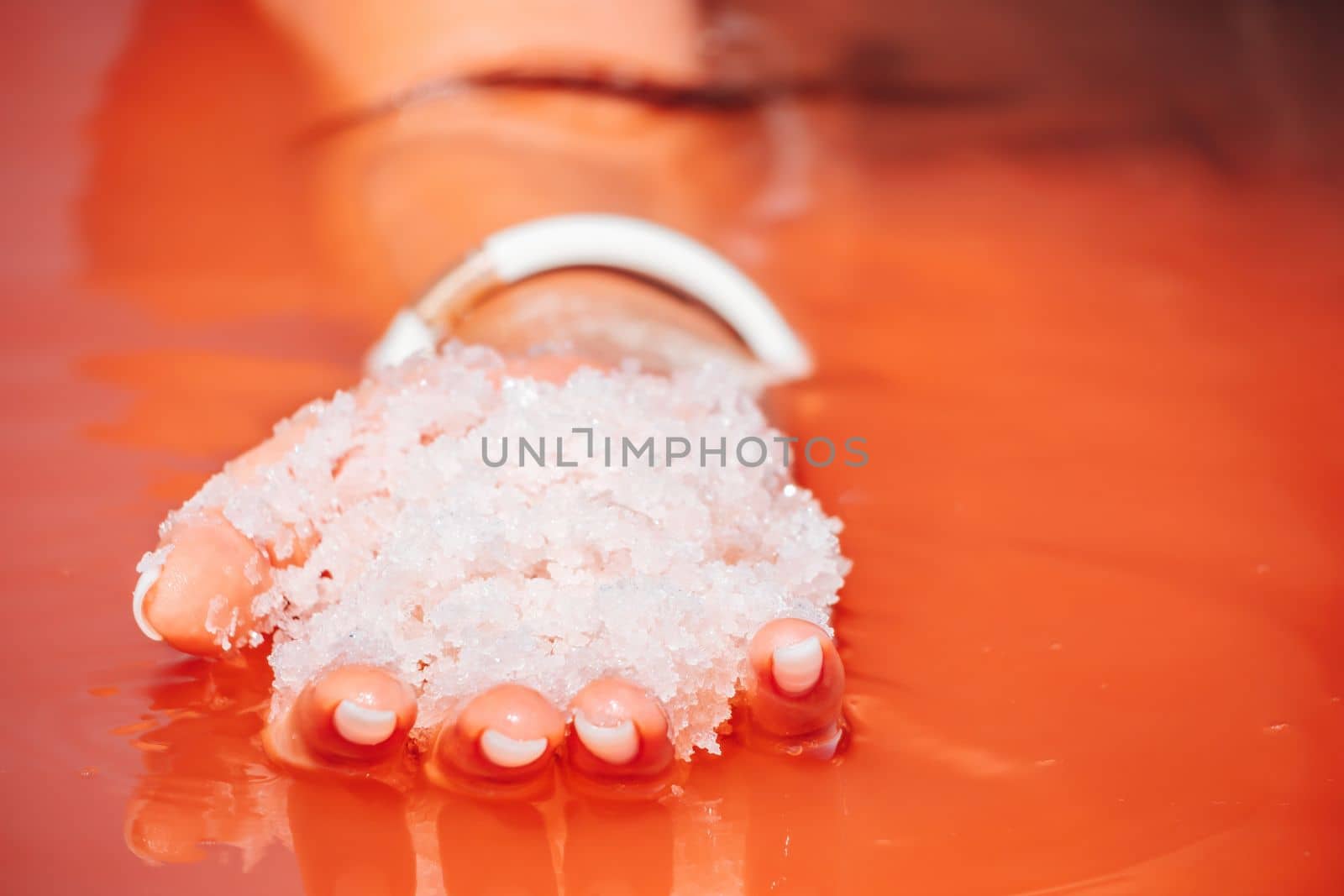 Salt mining. Salty pink lake with crystals of salt. Extremely salty pink lake, colored by microalgae with crystalline salt depositions