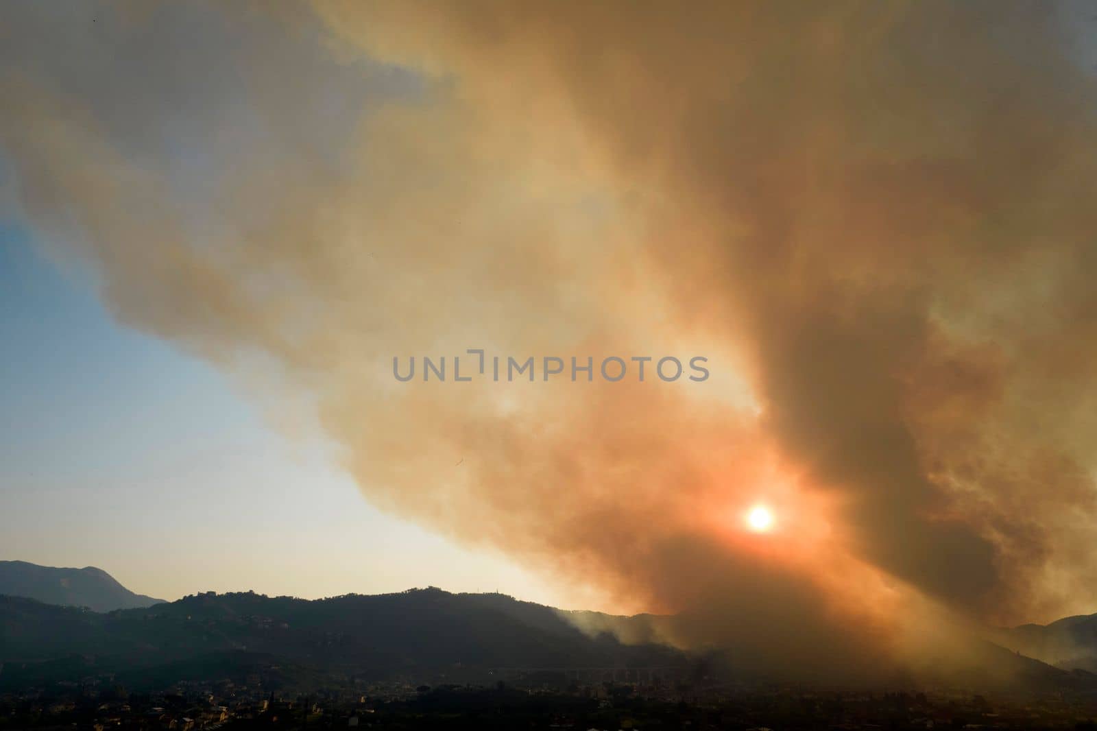 Photographic documentation of a large column of smoke caused by a forest fire in the upper Versilia Tuscany