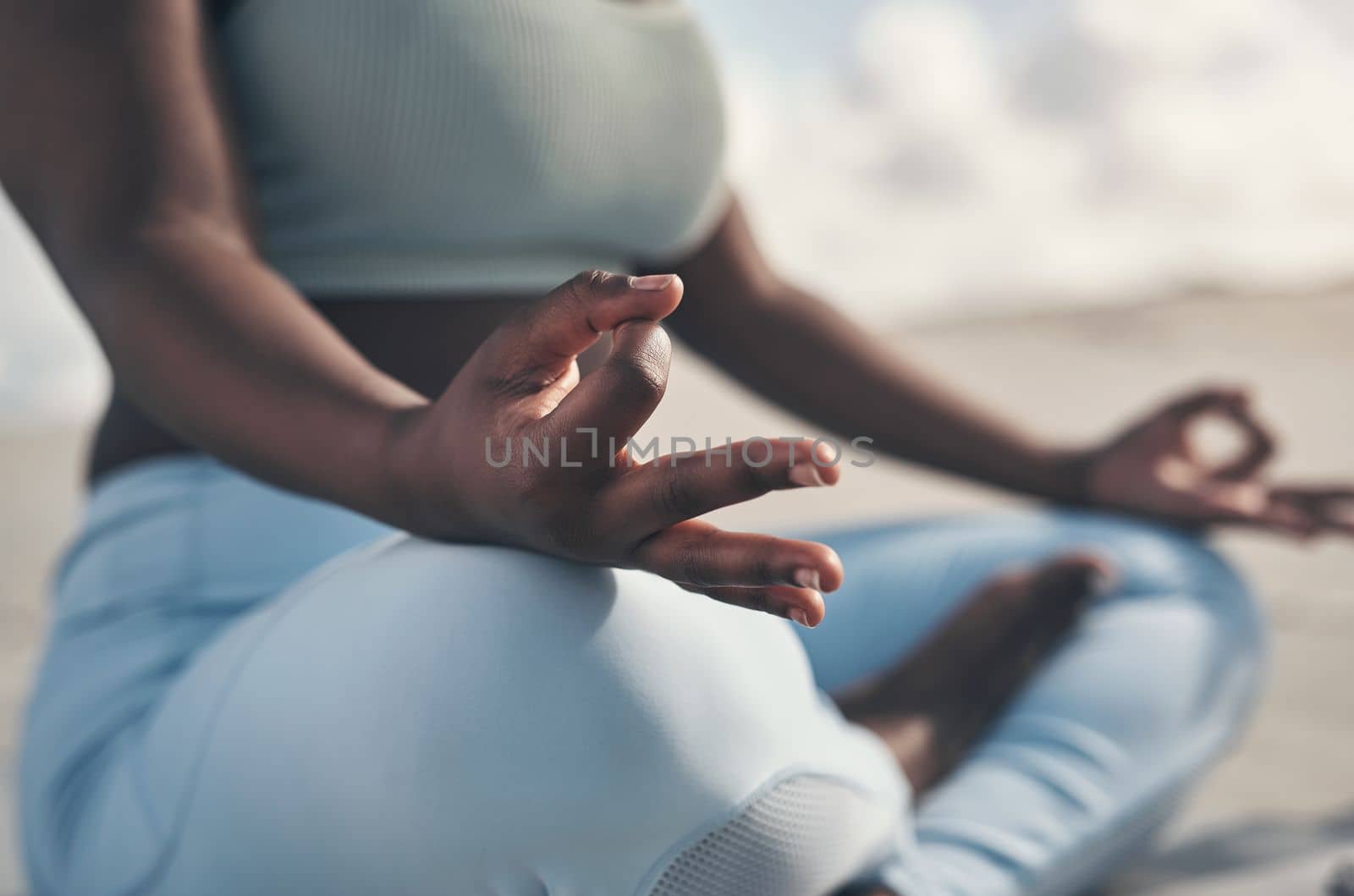 Yoga teaches you to listen to your body. a woman meditating during her yoga routine on the beach