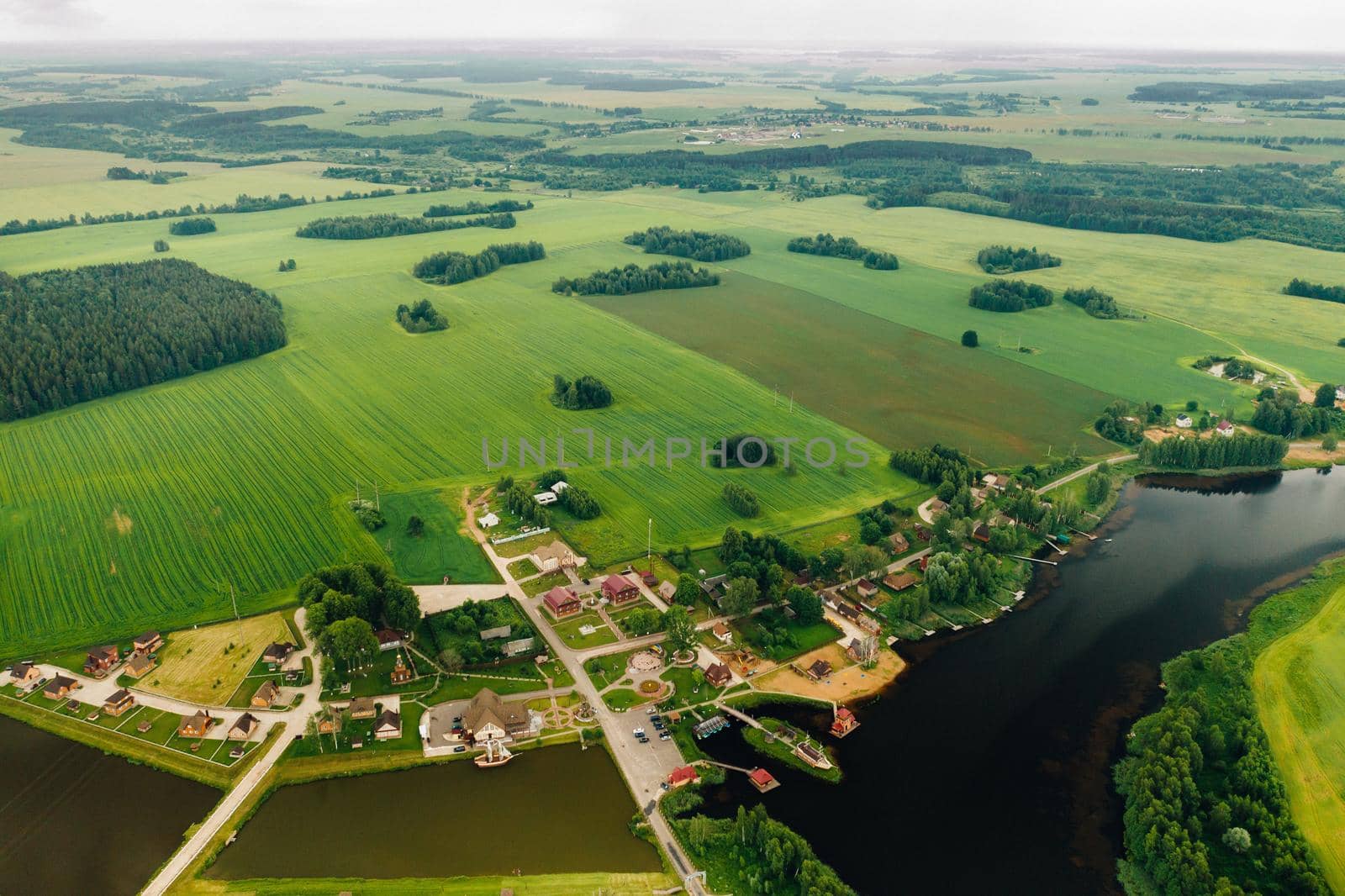 view from the height of the Lake in a green field in the form of a horseshoe and a village in the Mogilev region.Belarus.The Nature Of Belarus by Lobachad