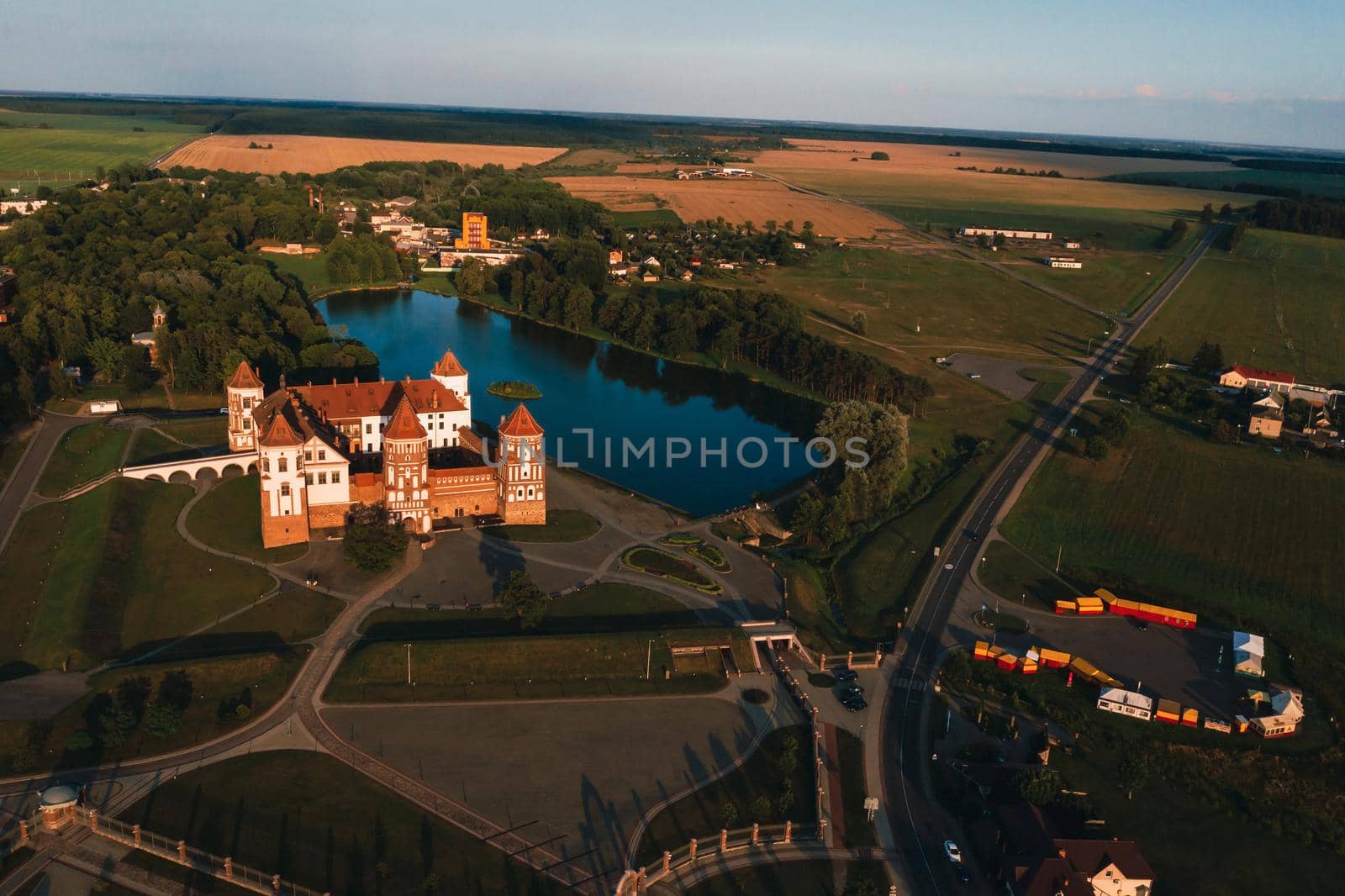 Mir orange castle with spiers near the lake a top view in Belarus in Nesvizh by Lobachad