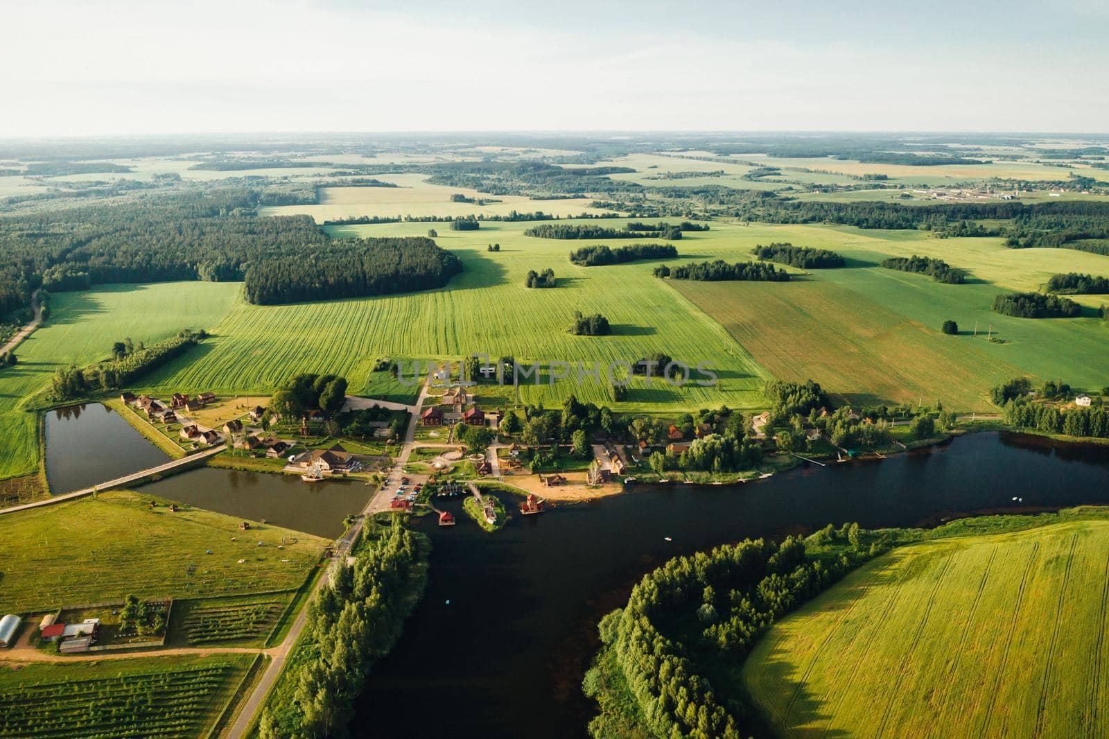 view from the height of the Lake in a green field in the form of a horseshoe and a village in the Mogilev region.Belarus.The Nature Of Belarus by Lobachad