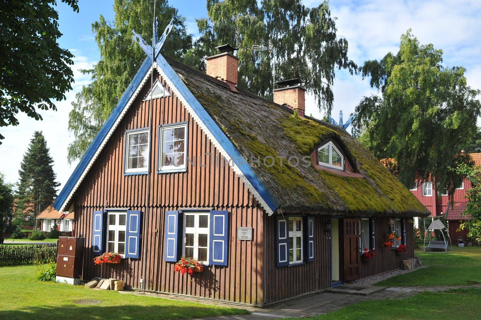 old old wooden house, red, in the European country of Lithuania, in the spa town of Nida, on the Curonian Spit. by Lobachad