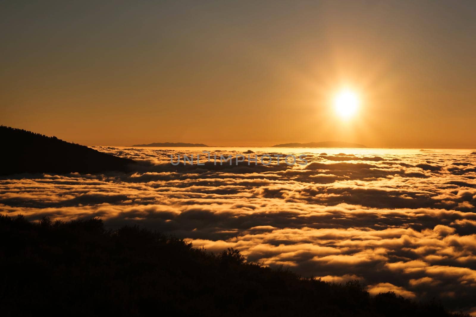 a spectacular sunset above the clouds in the national Park of the volcano Teide on Tenerife. Excellent sunset in the Canary Islands.