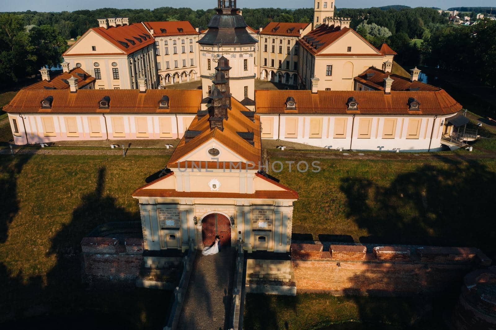 Wedding of newlyweds on the background of the castle in Nesvizh from a height, Minsk region, Belarus.Nesvizh castle, unrecognizable.