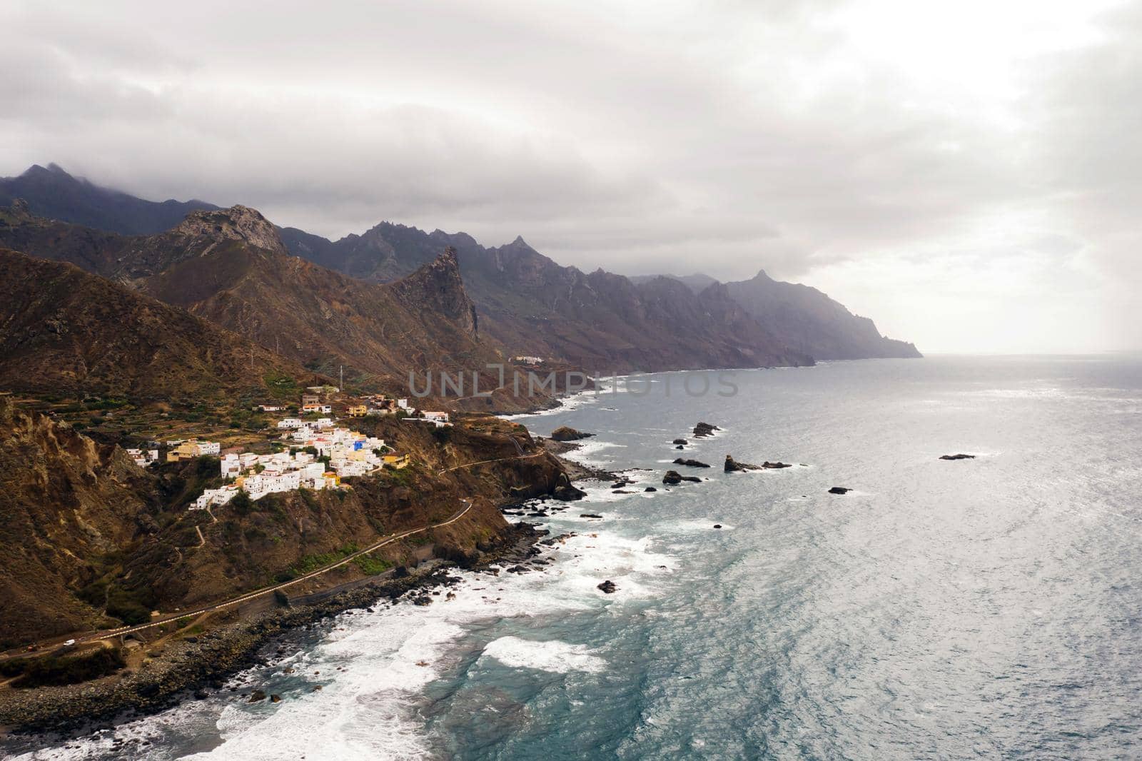 Rough rocky cliffs in the North of Tenerife. Beautiful Benijo beach in the Canary Islands. Rocks, volcanic rocks, Atlantic ocean by Lobachad