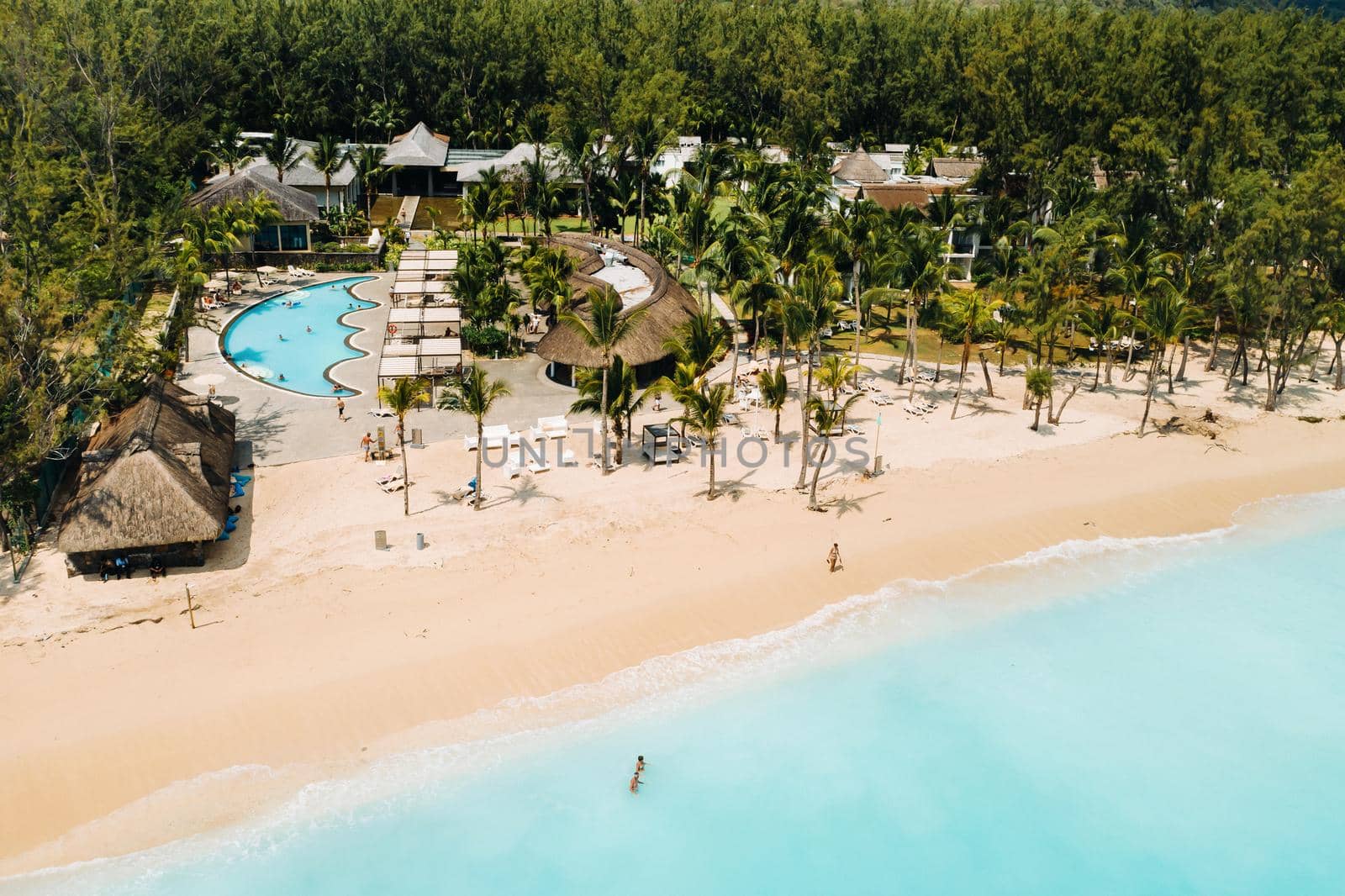 Luxury beach with mountain in Mauritius. Sandy beach with palms and blue ocean. Aerial view. by Lobachad