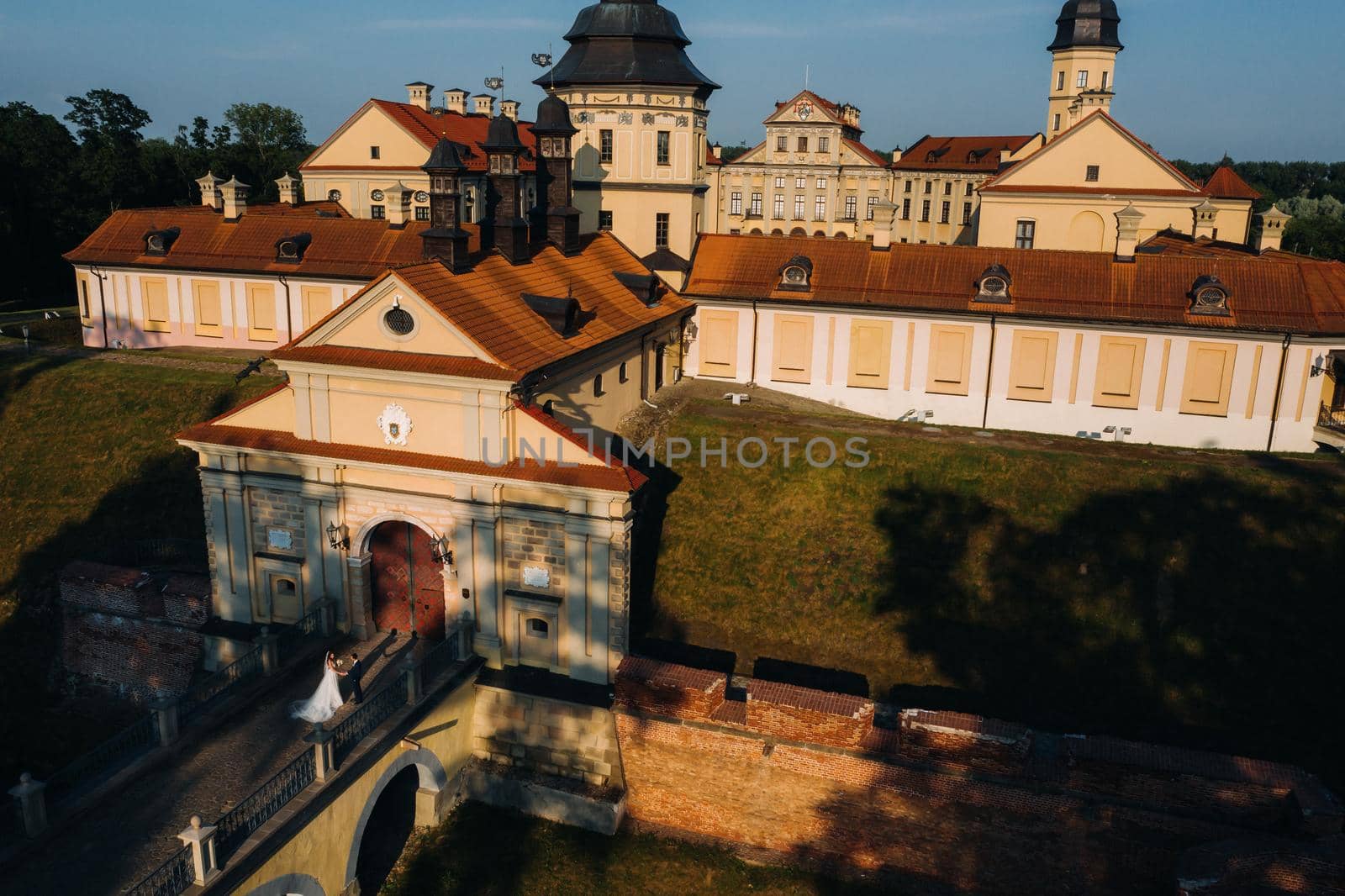 Wedding of newlyweds on the background of the castle in Nesvizh from a height, Minsk region, Belarus.Nesvizh castle, unrecognizable by Lobachad