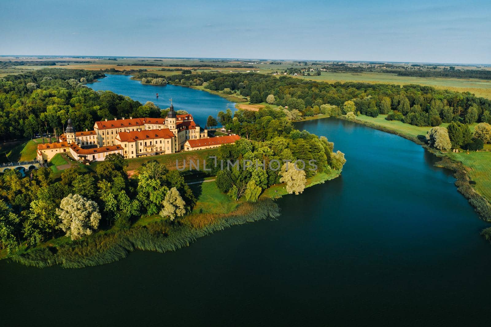 Aerial photo Nesvizh castle in autumn evening, Belarus Minsk, top view by Lobachad