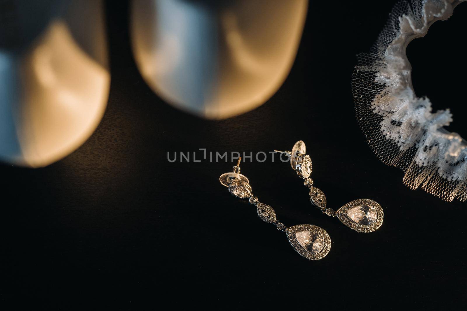 Accessories for the bride. Wedding Earrings on a black background. by Lobachad