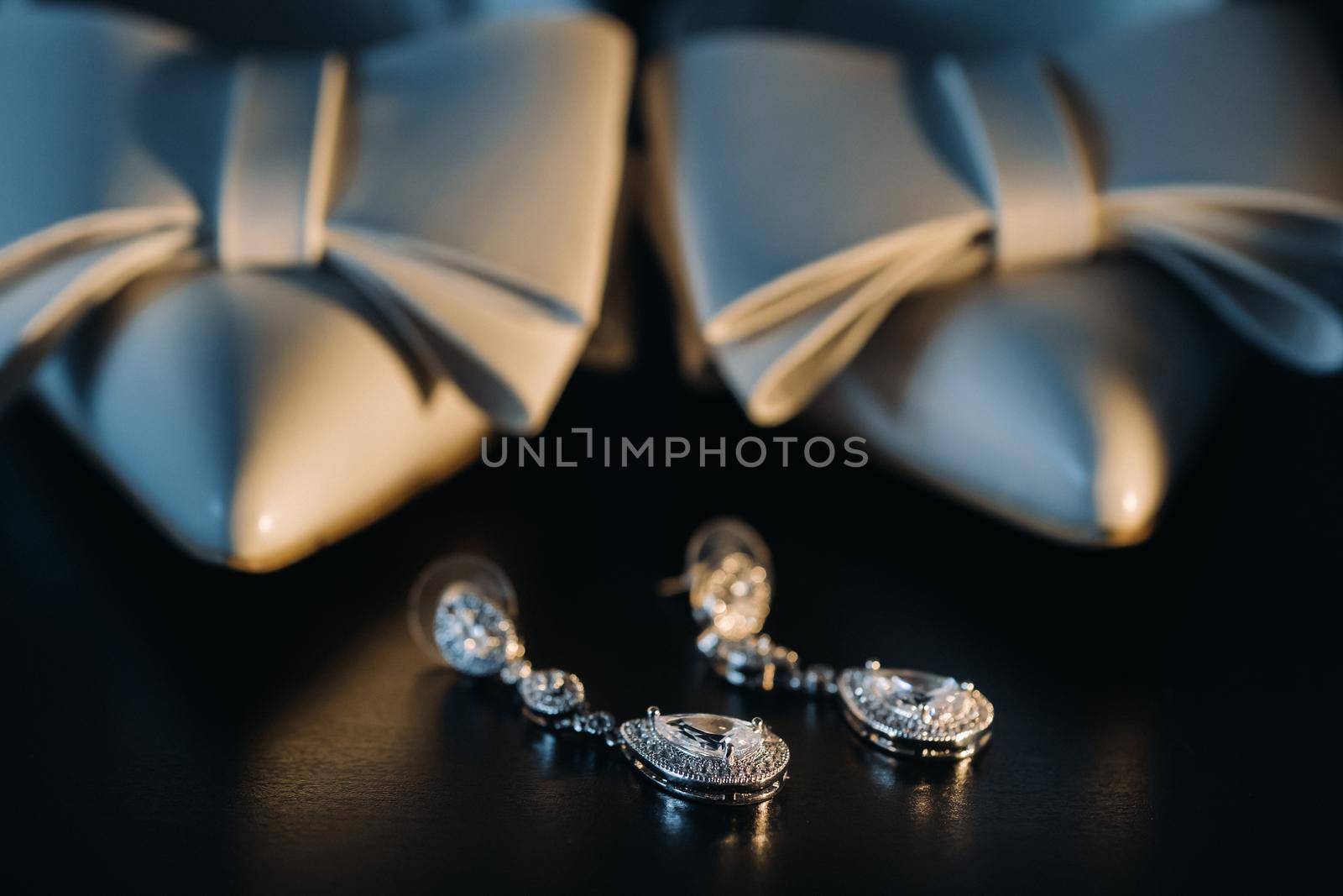 Accessories for the bride. Wedding Earrings on a black background. by Lobachad