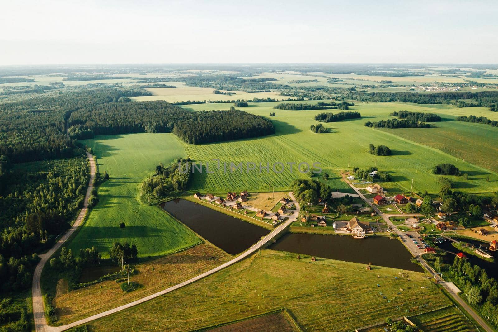 view from the height of the Lake in a green field in the form of a horseshoe and a village in the Mogilev region.Belarus.The Nature Of Belarus by Lobachad