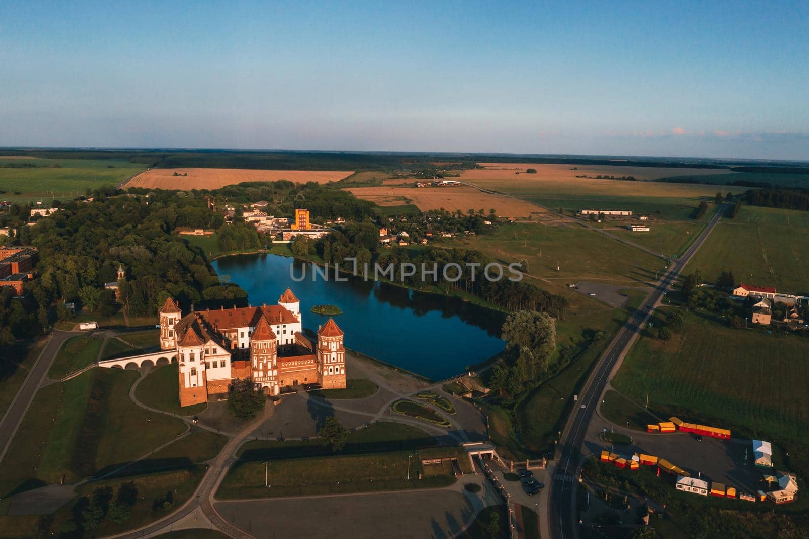 Mir castle with spires near the lake top view in Belarus near the city of Mir by Lobachad