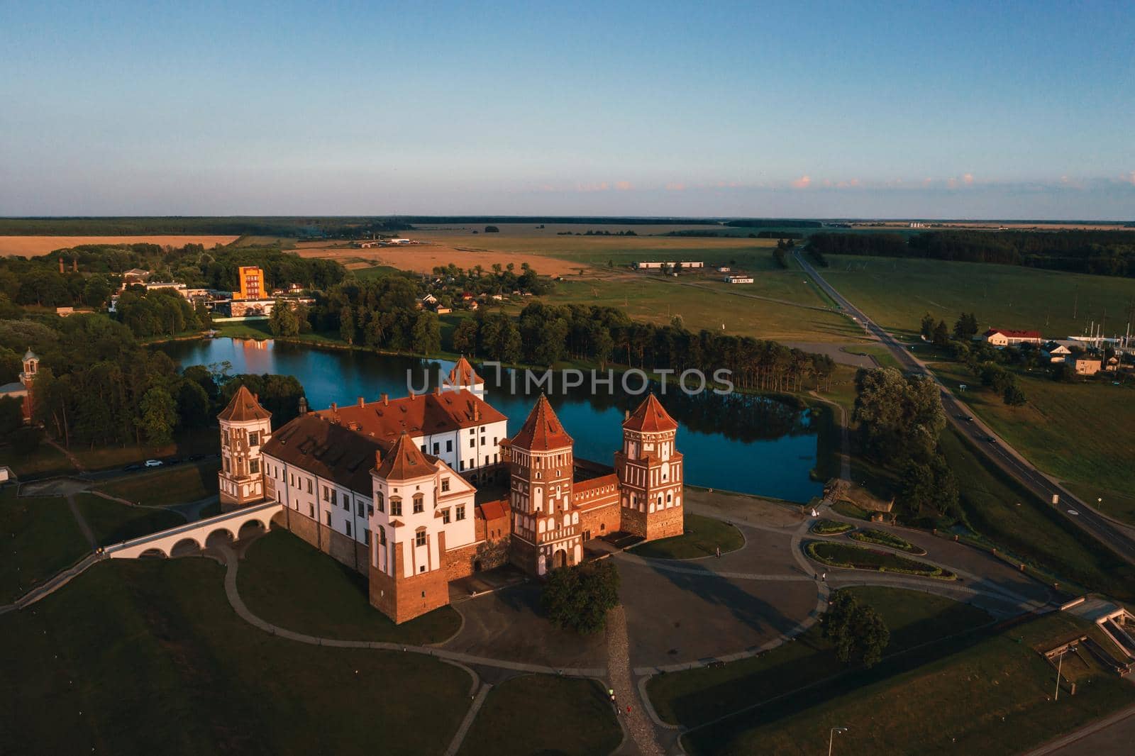 Mir castle with spires near the lake top view in Belarus near the city of Mir by Lobachad