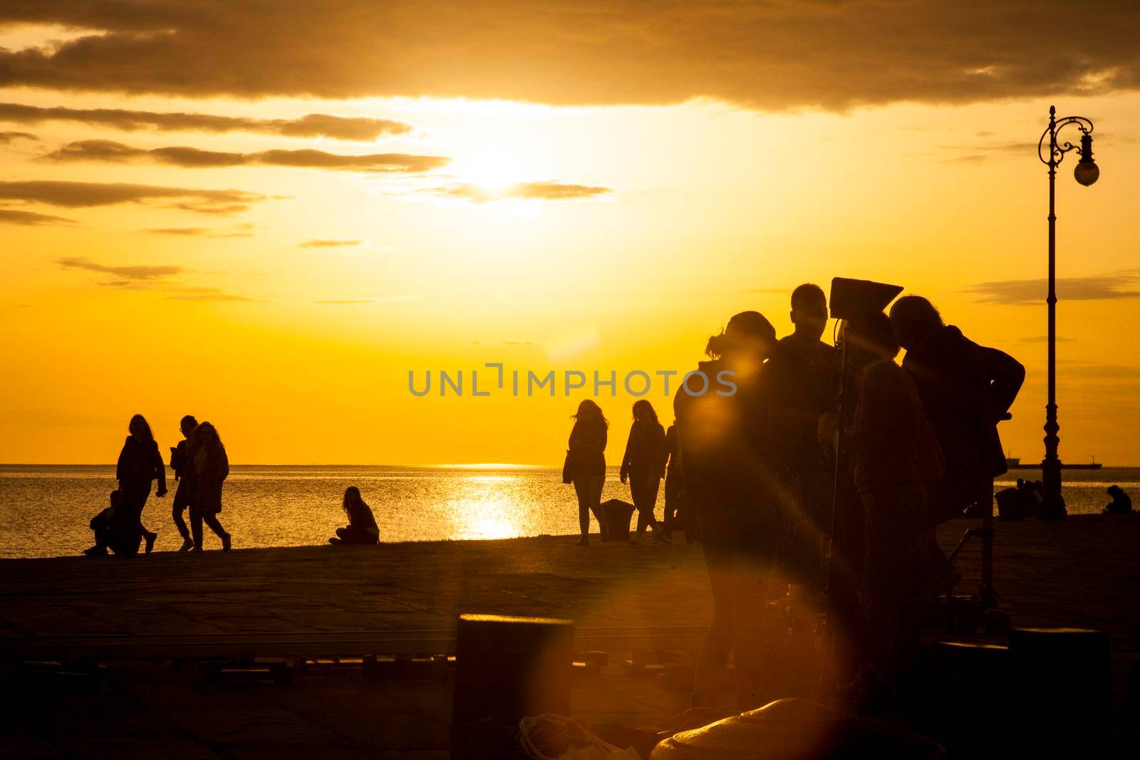 TRIESTE, ITALY - APRIL, 17: Behind the scene. Film crew team filming movie scene on outdoor location at sunset on April 17, 2018