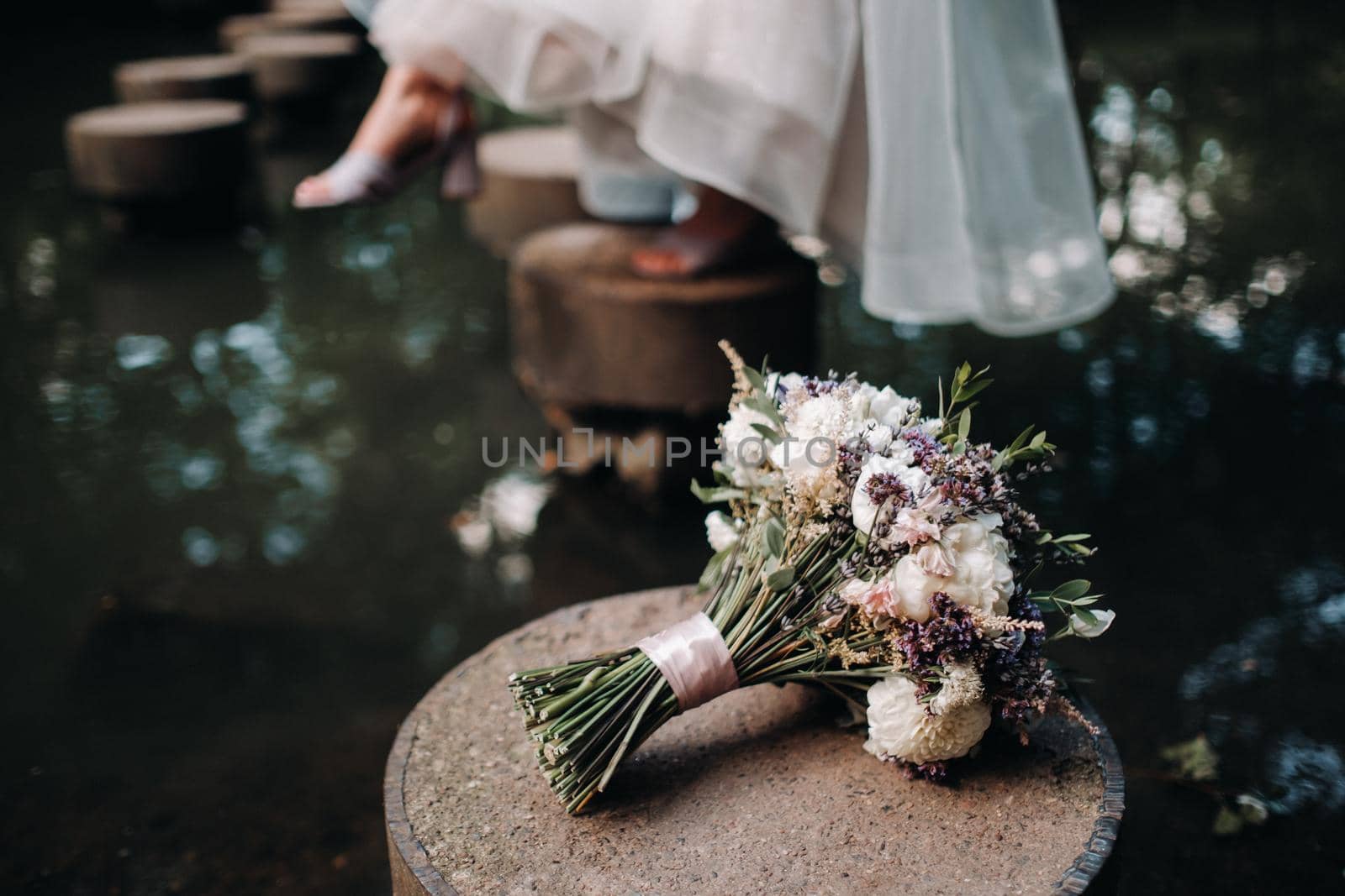 wedding bouquet with roses on the table and a boutonniere.The decor at the wedding by Lobachad