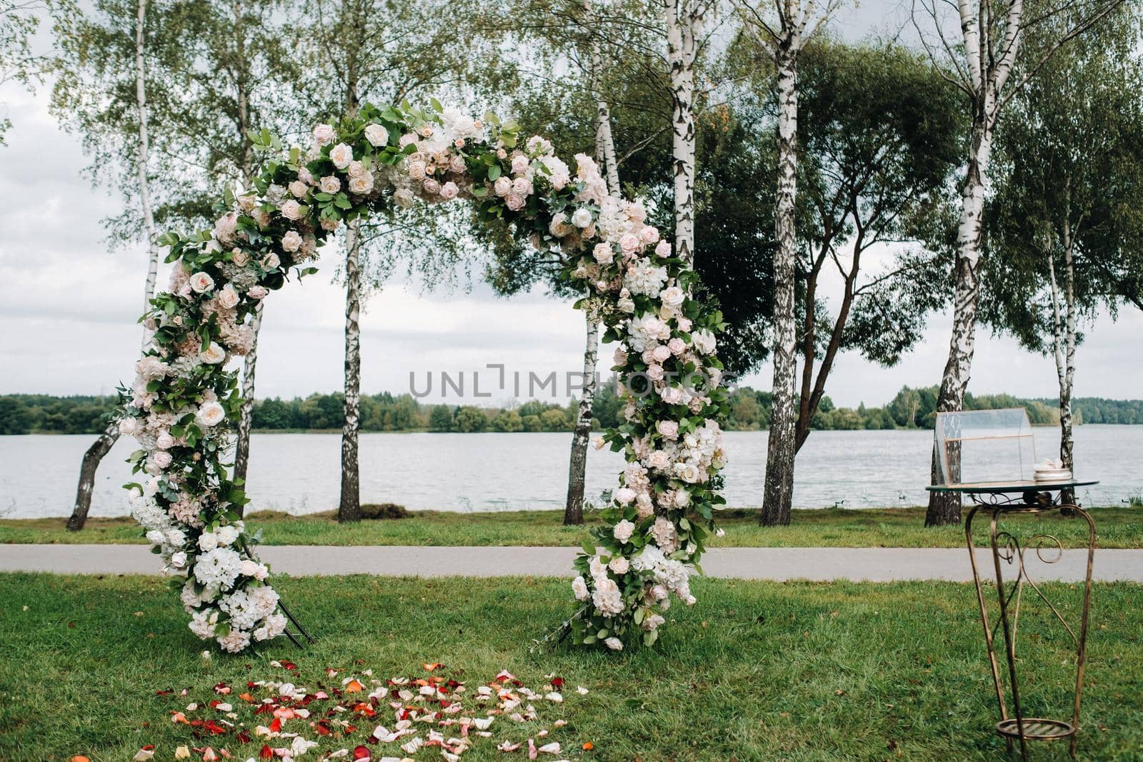 Wedding ceremony on the street on the green lawn.Decor with fresh flowers arches for the ceremony.