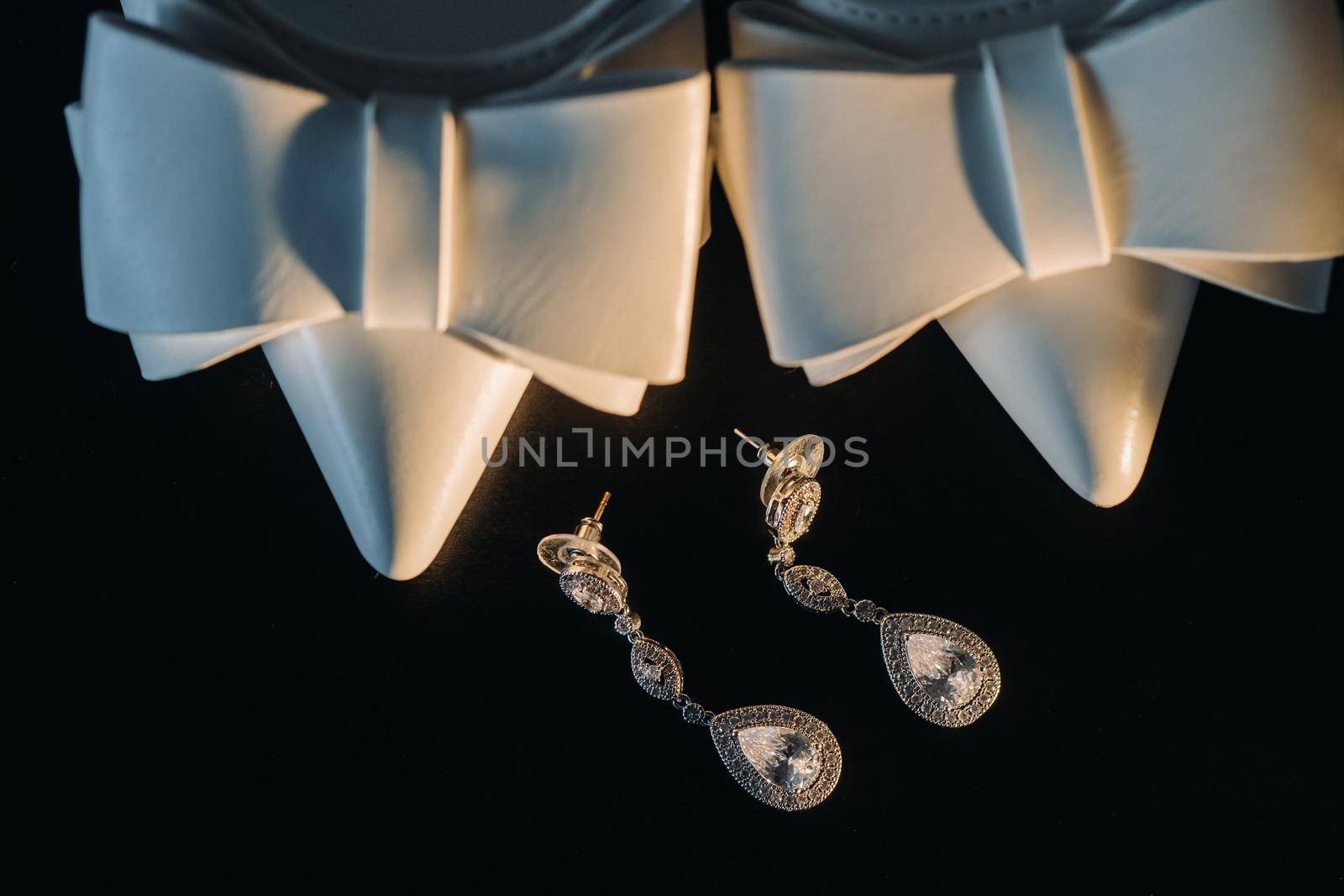Accessories for the bride. Wedding Earrings on a black background..
