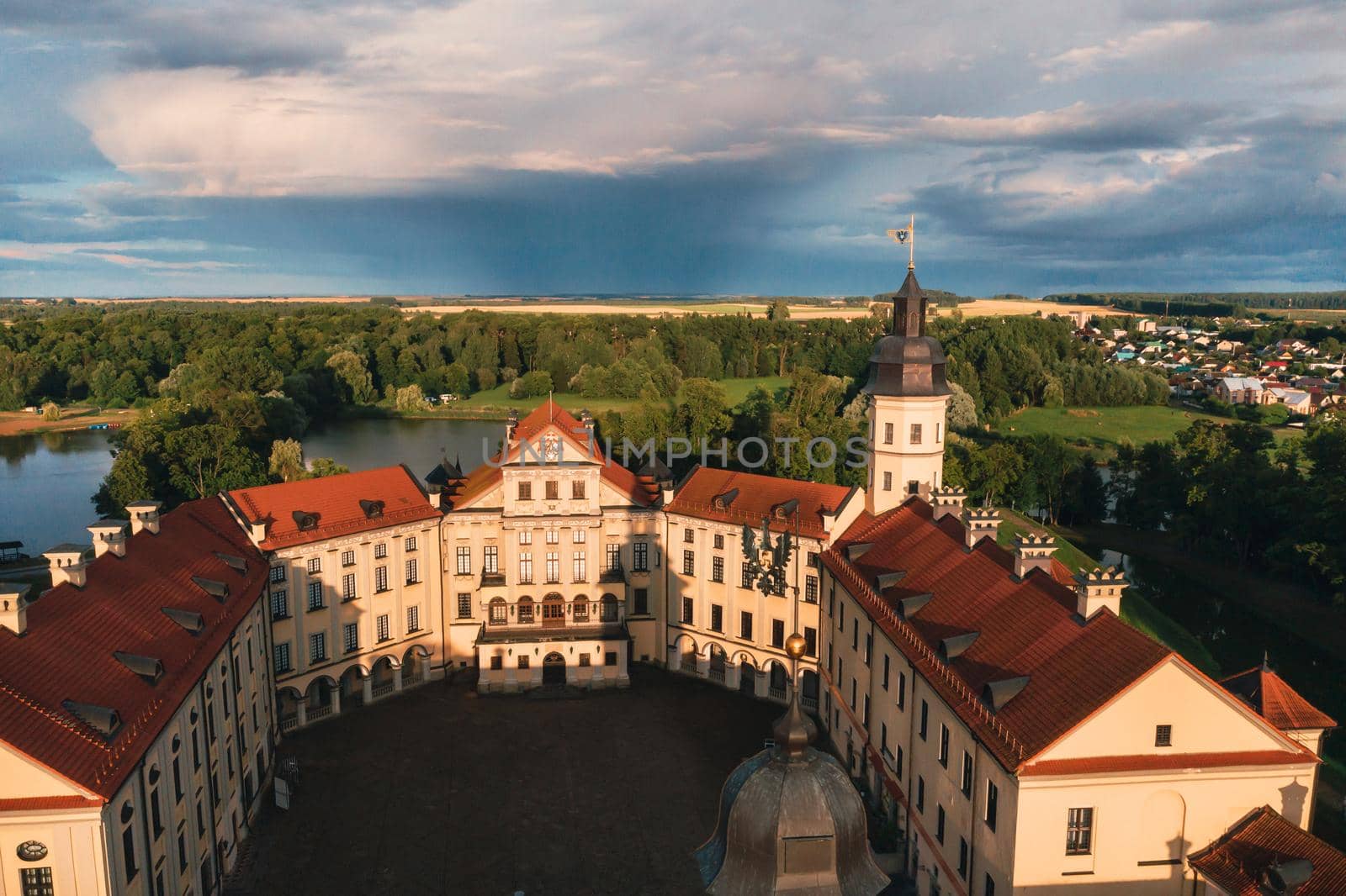 Aerial photo Nesvizh castle in autumn evening, Belarus Minsk, top view by Lobachad