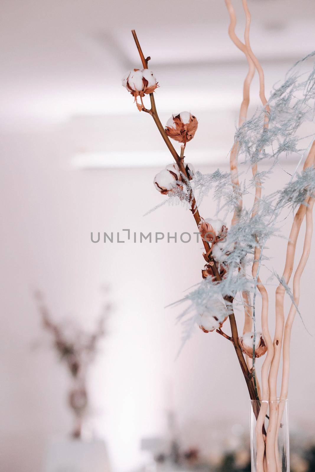 decoration with fluffy flowers on the table in winter style at the wedding.