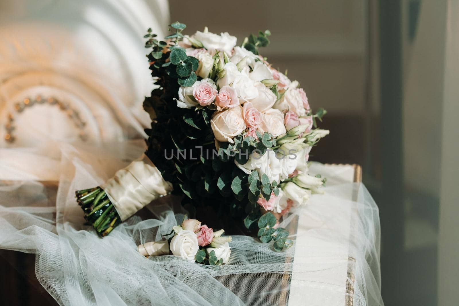 wedding bouquet with roses and boutonniere.The decor at the wedding.