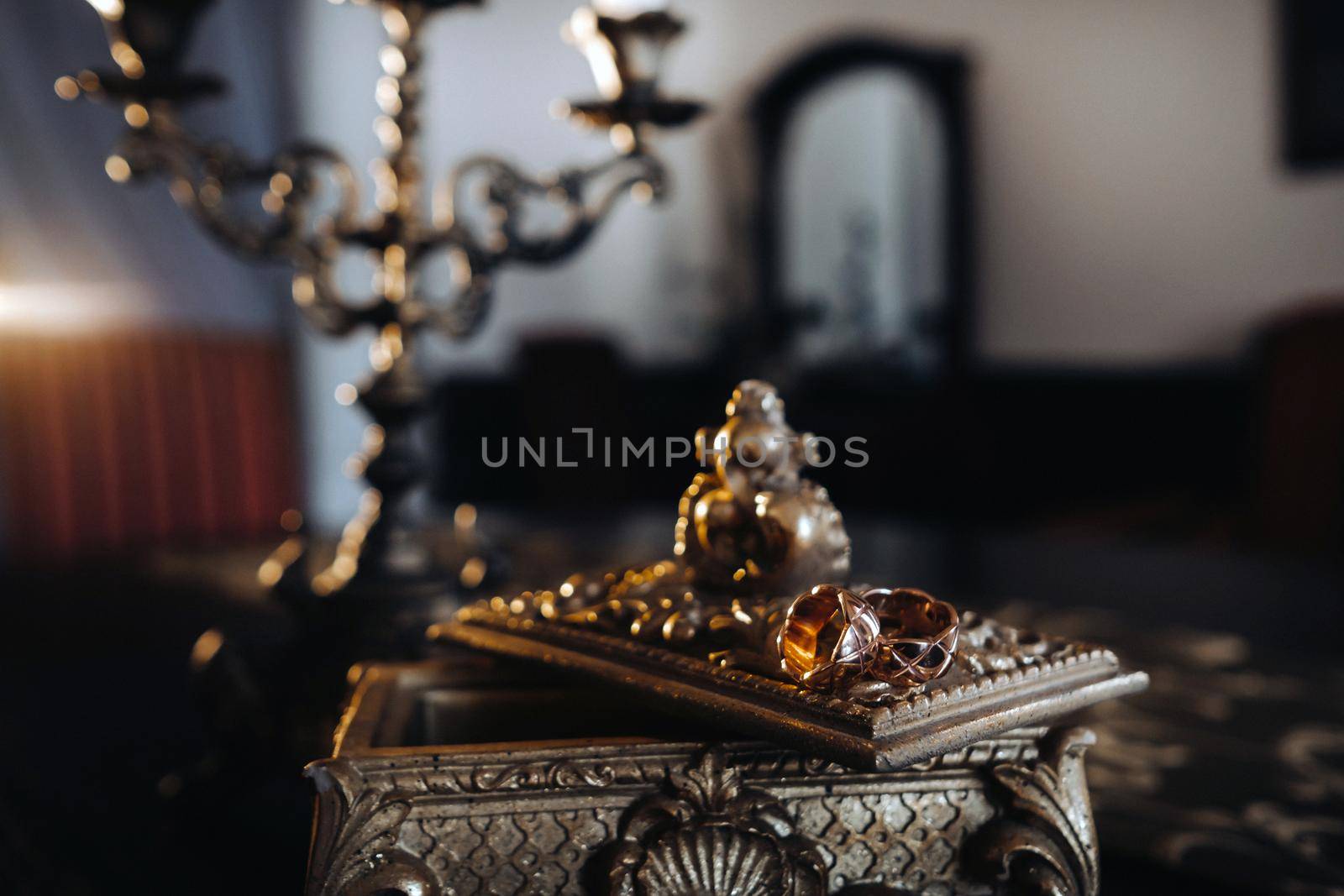 Gold wedding rings lie on an antique jewelry box. Wedding rings for ceremonies.