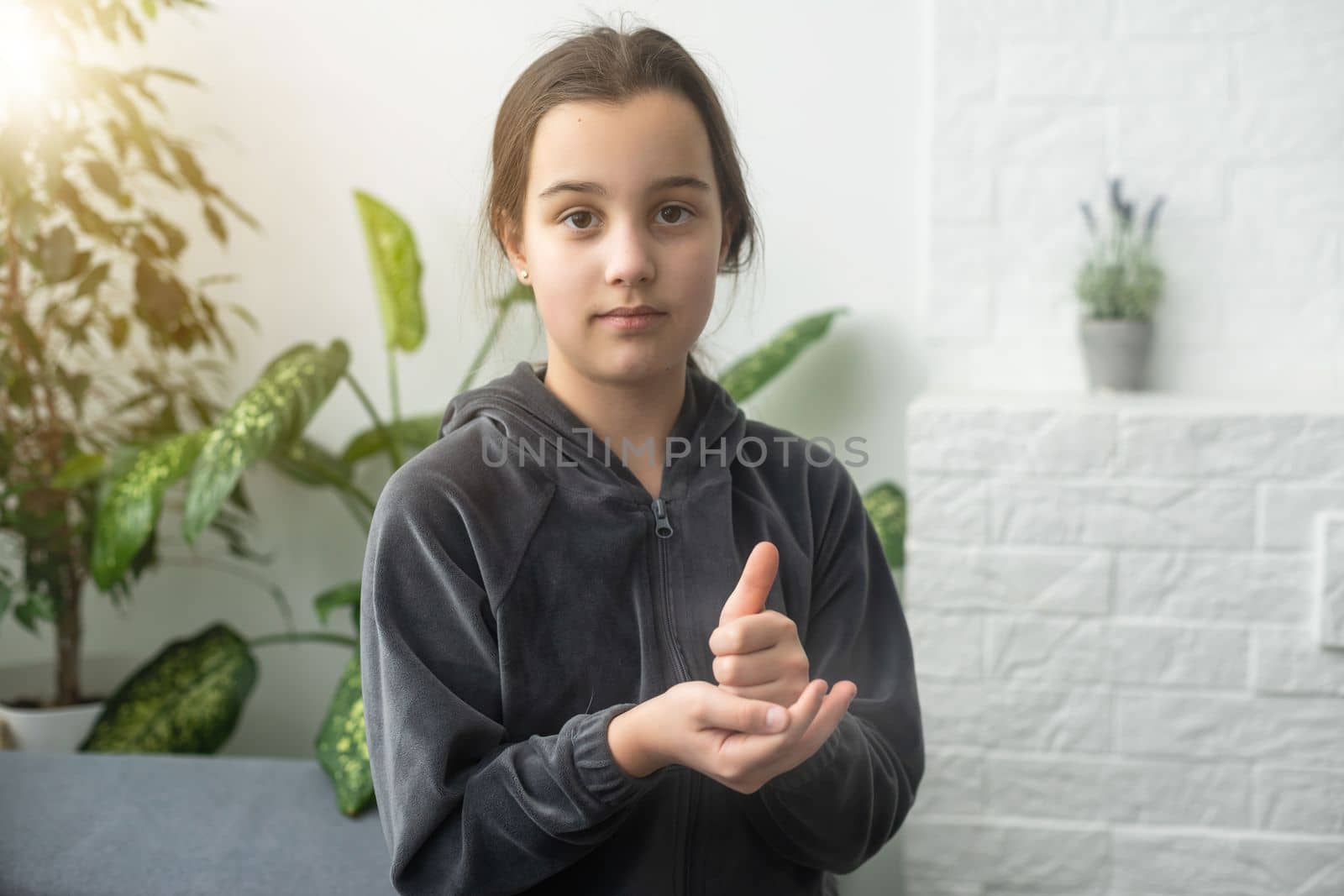 Cute deaf mute girl using sign language on light background by Andelov13