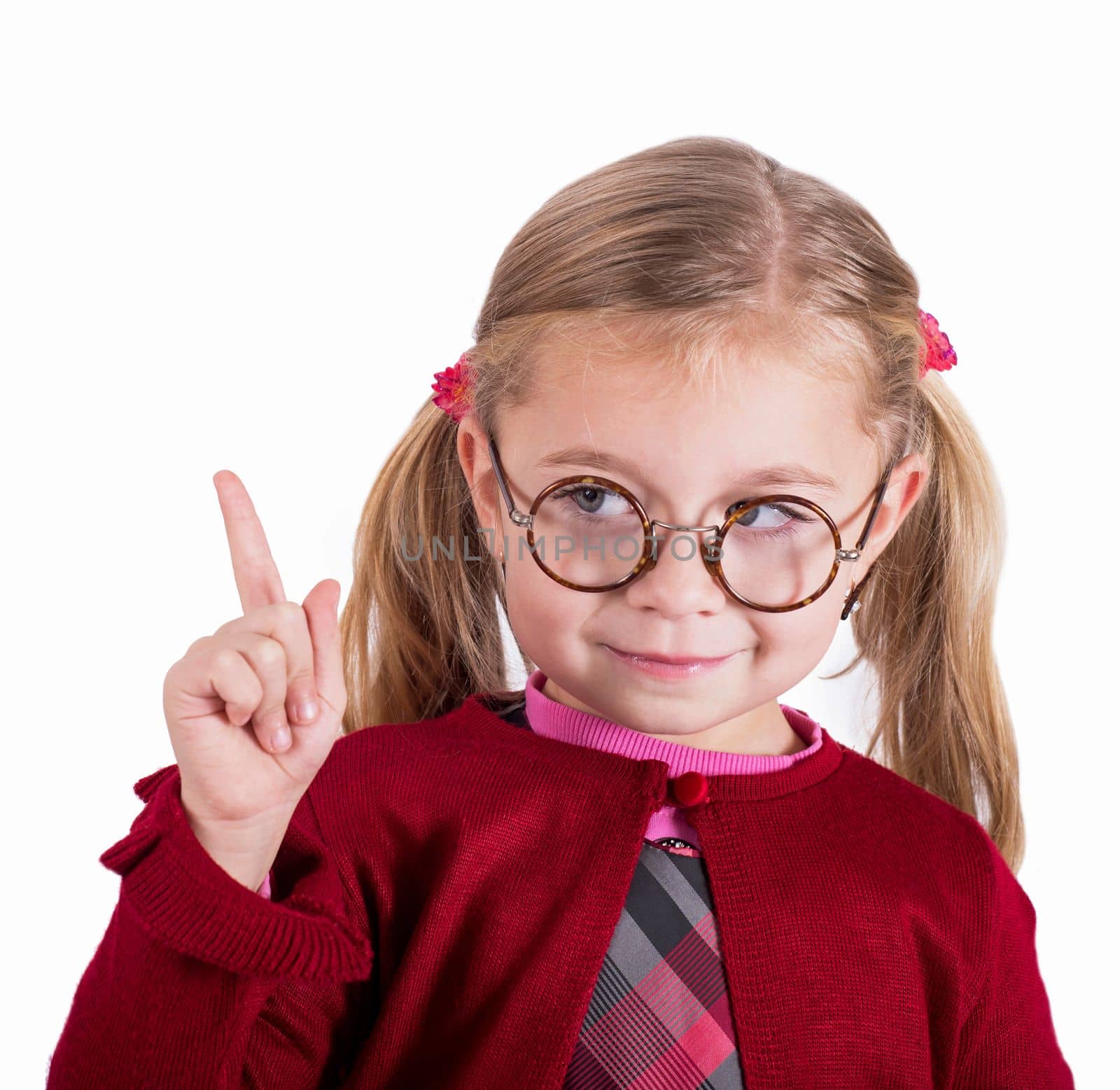 Close-up portrait of little girl wearing glasses. The concept of eye disease and education. An inquisitive child. Beautiful little girl looks through vintage glasses. The eye is enlarged by aprilphoto