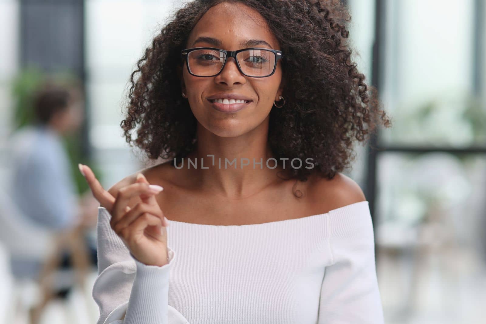 Portrait of business woman showing finger gesture to the side