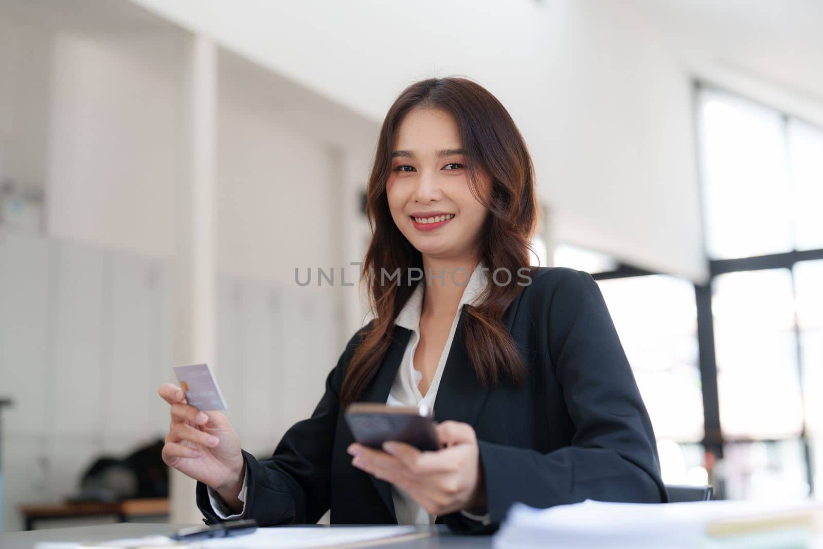 Woman makes a purchase on the smart phone with credit card, online payment, shopping online, e-commerce, internet banking concept.