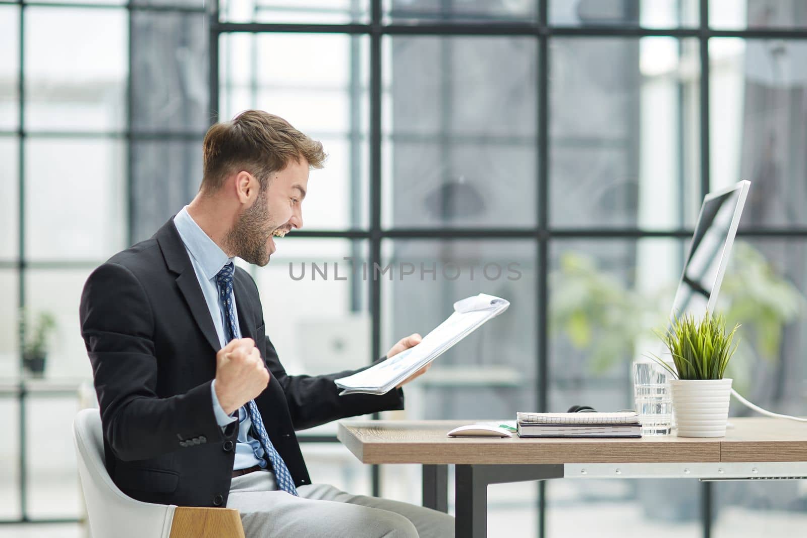 energetic businessman celebrating in office