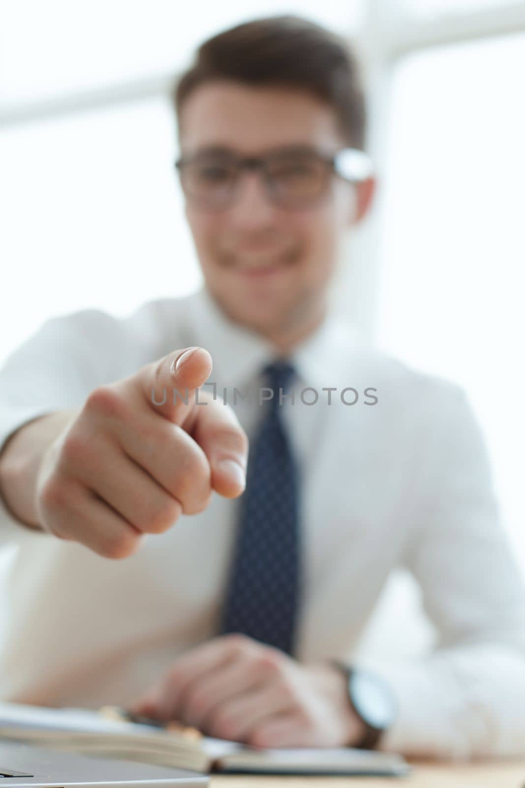 businessman pointing his finger to you at office