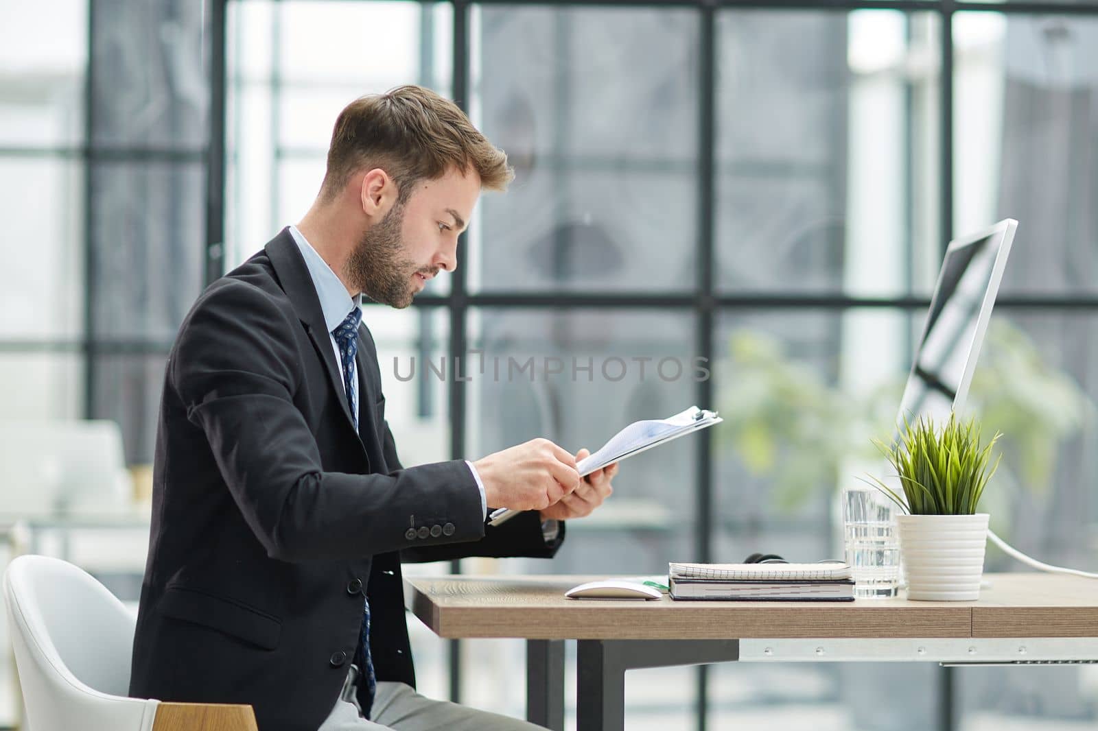 Businessman Taking Papers From Secretary In Office