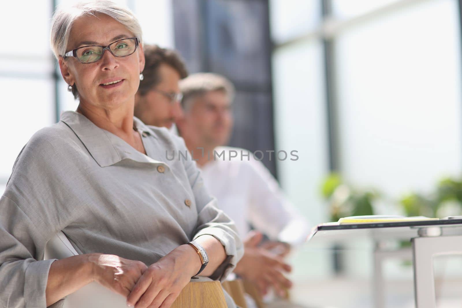 60 year old business woman in a work environment.