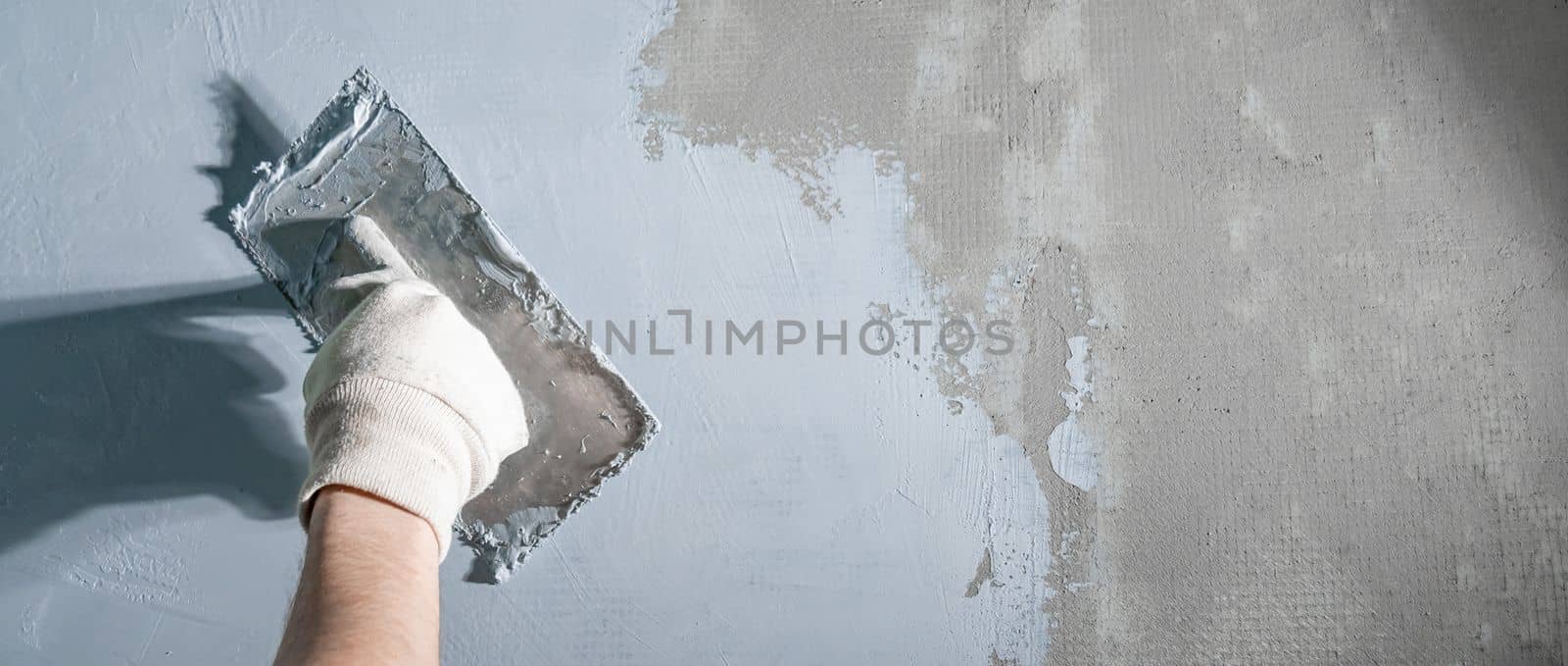 masonry tools for building and repairing walls and floors, trowel in hand. Banner with copy space by Edophoto
