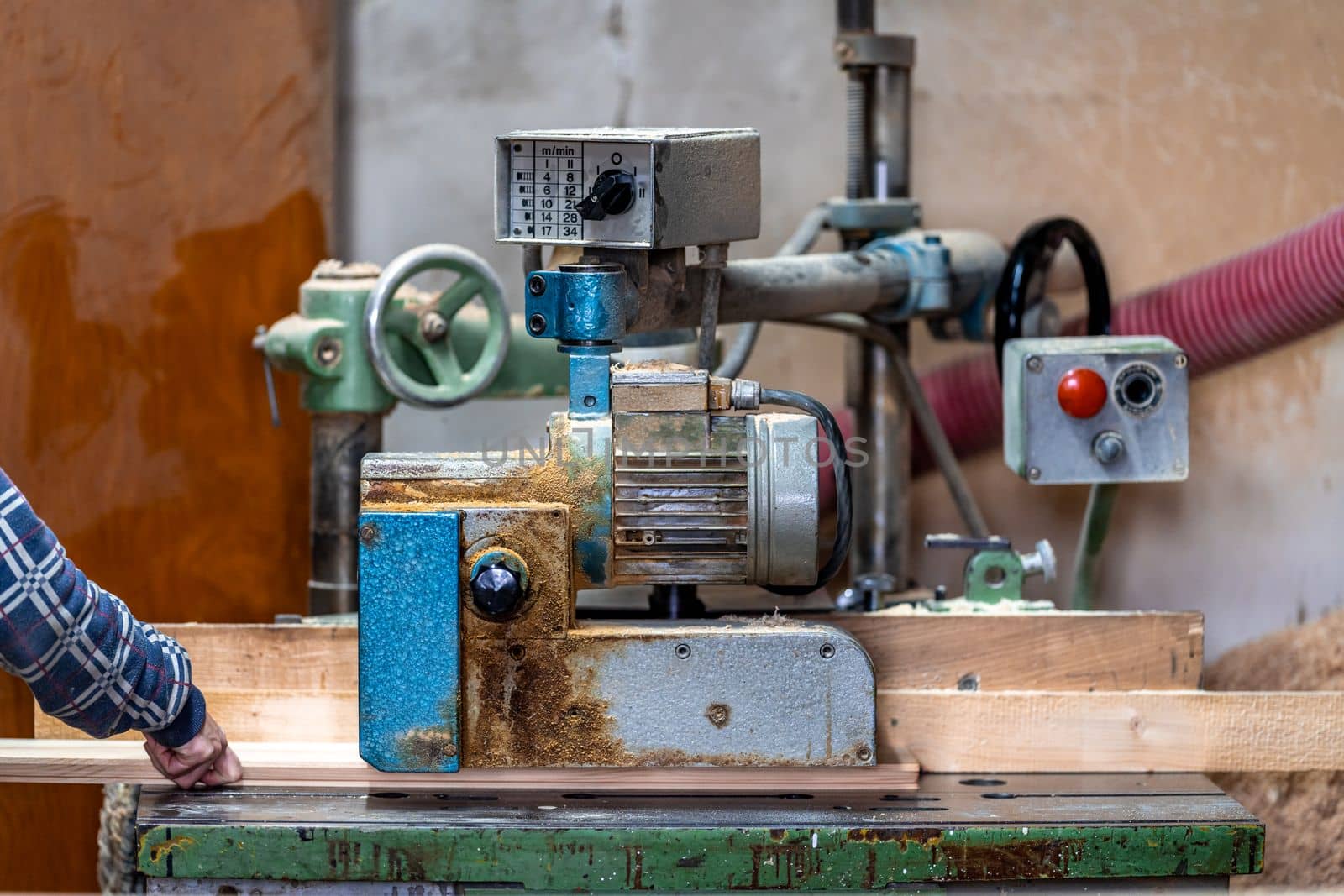 planing boards on a machine in a joinery.