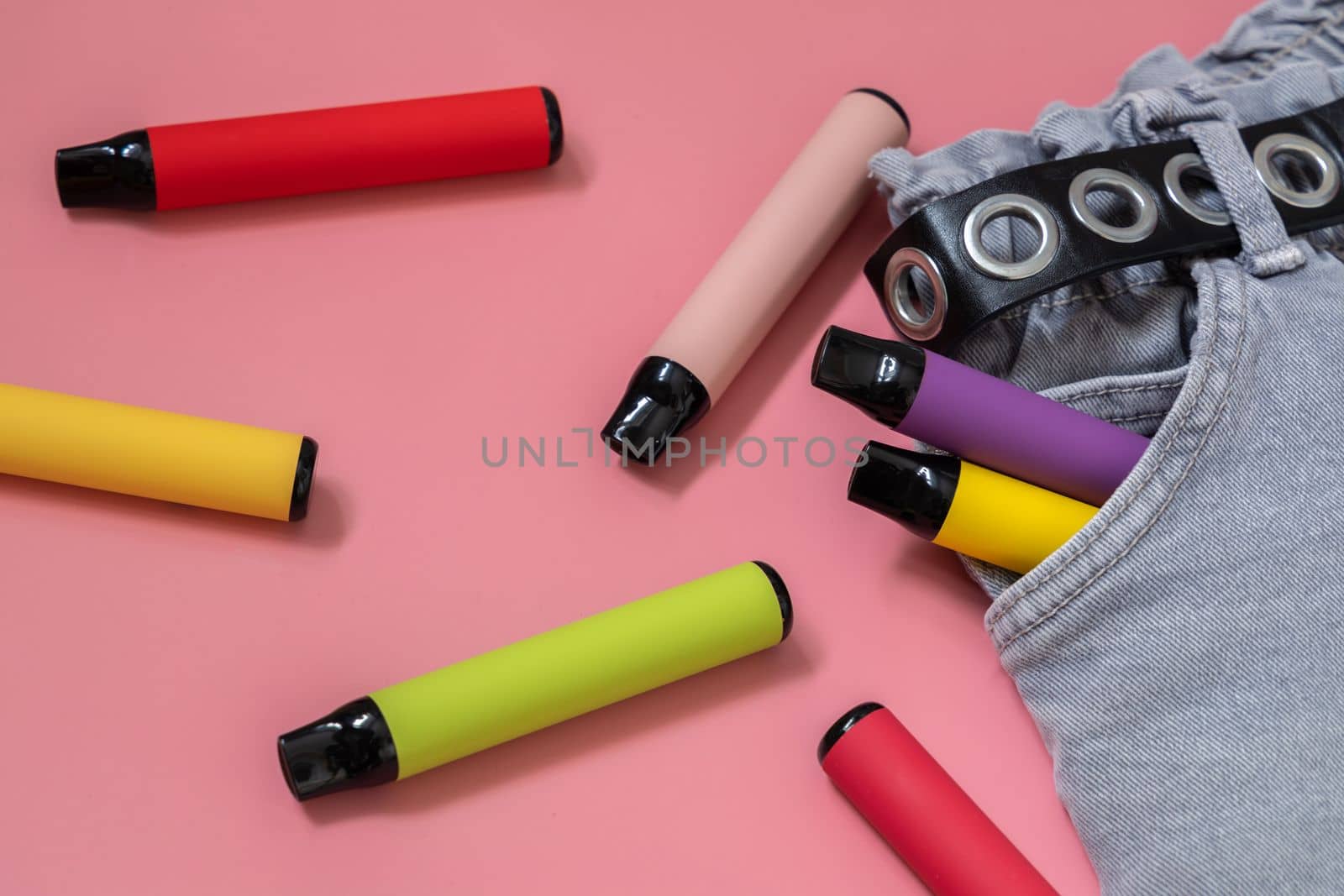 Layout of colorful disposable vapor stick on a light background. Concept of modern e-smoking, vaping and nicotine, electronic cigarettes