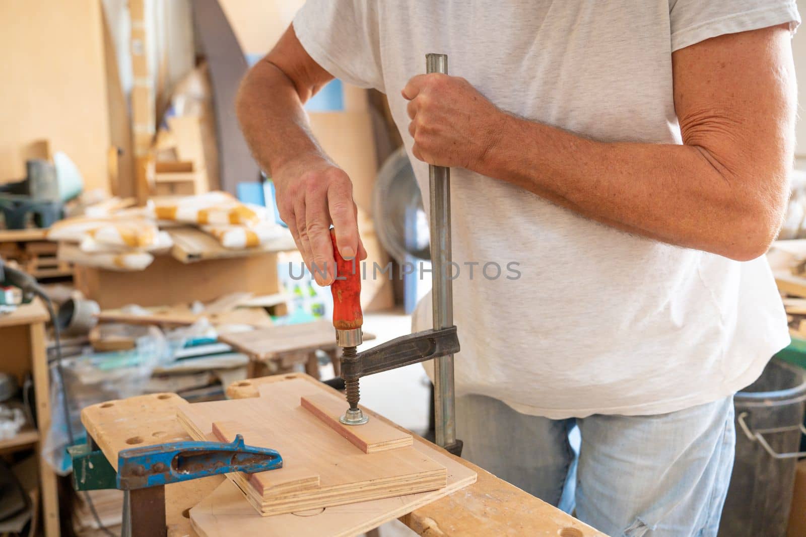 Closeup portrait of unknown unrecognizable man carpenter working in his joinery wooden furniture. by PaulCarr